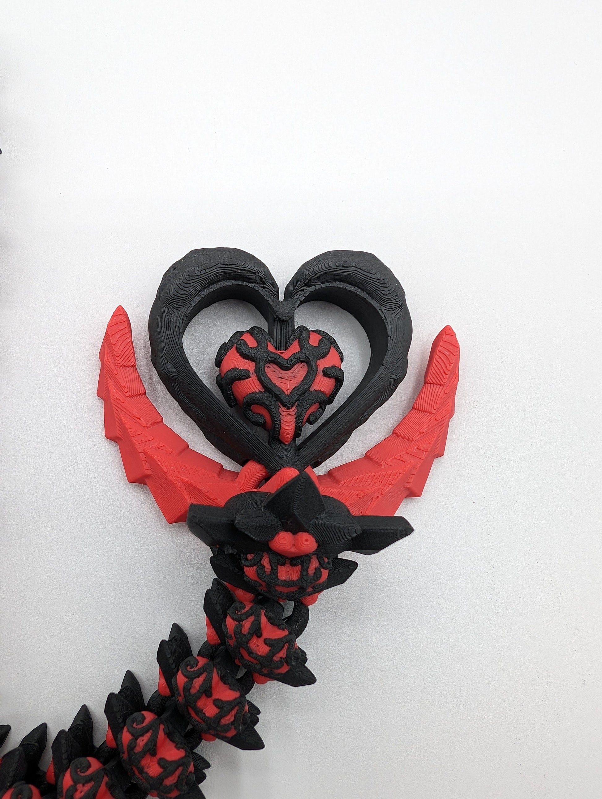 Discover the magic of our Valentine Heart Dragon! This enchanting articulating dragon not only graces your bookshelf with whimsy but also makes for a heartfelt and unforgettable Valentine's Day gift. Elevate your space with love!