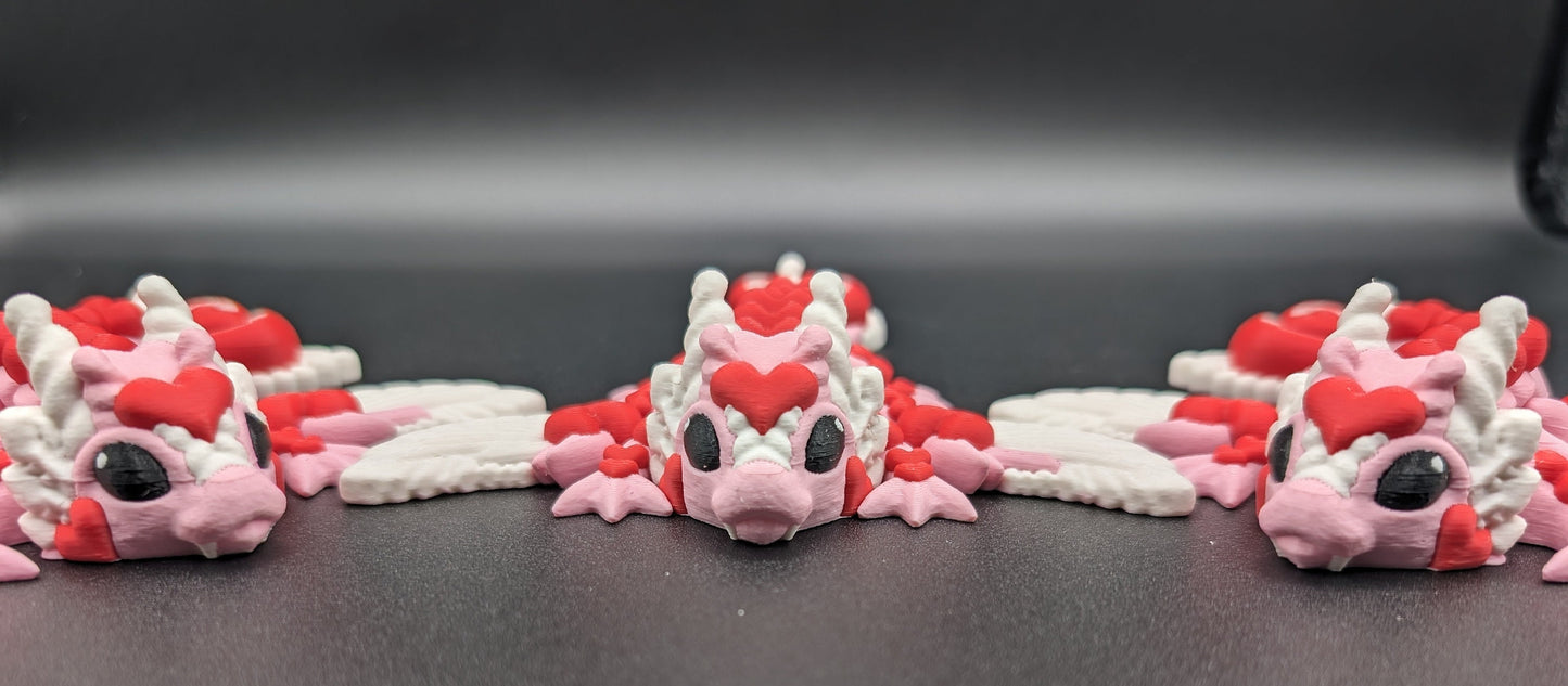 Discover the magic of our Valentine Heart Dragon! This enchanting articulating dragon not only graces your bookshelf with whimsy but also makes for a heartfelt and unforgettable Valentine's Day gift.