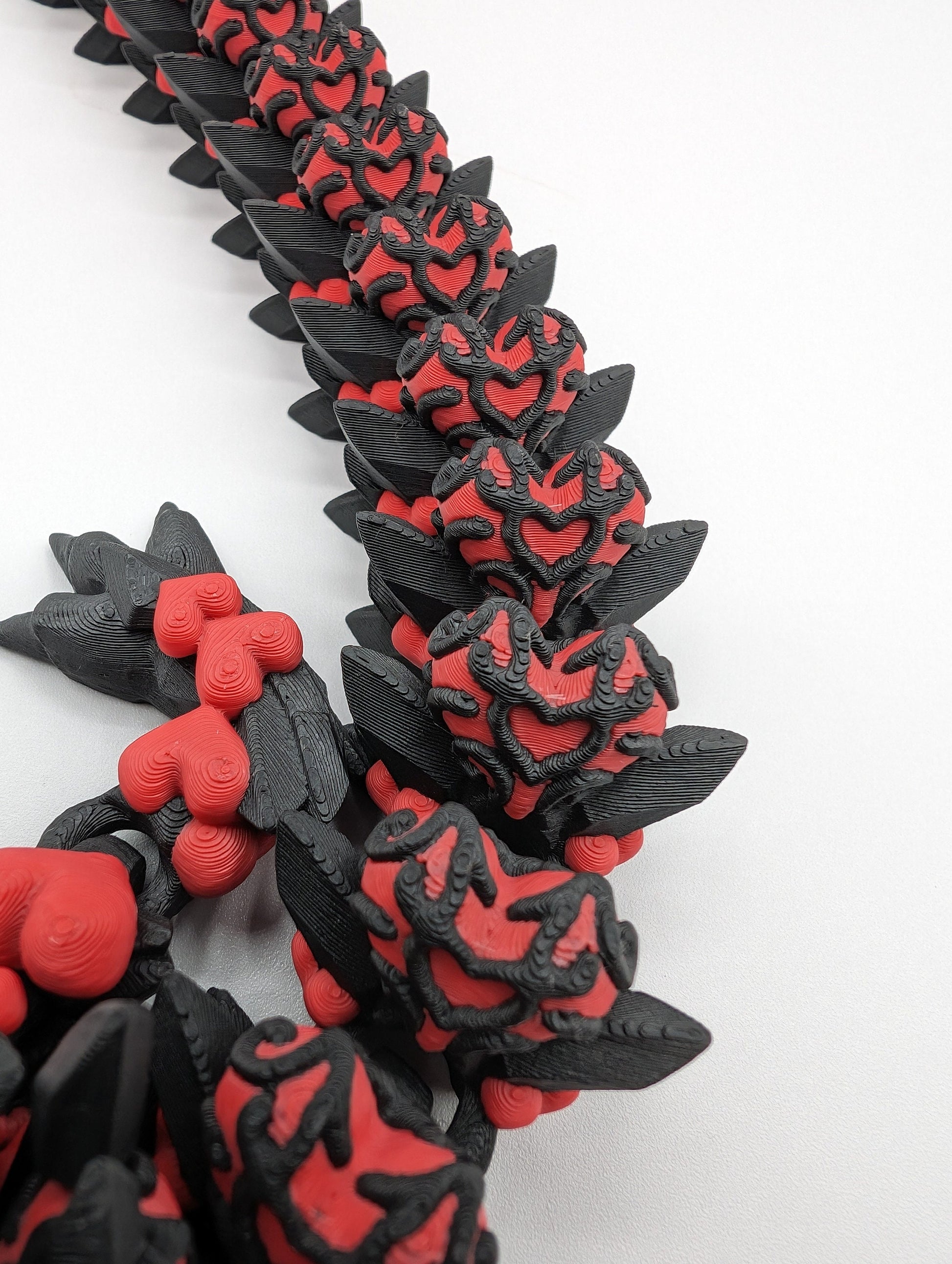 Discover the magic of our Valentine Heart Dragon! This enchanting articulating dragon not only graces your bookshelf with whimsy but also makes for a heartfelt and unforgettable Valentine's Day gift. Elevate your space with love!