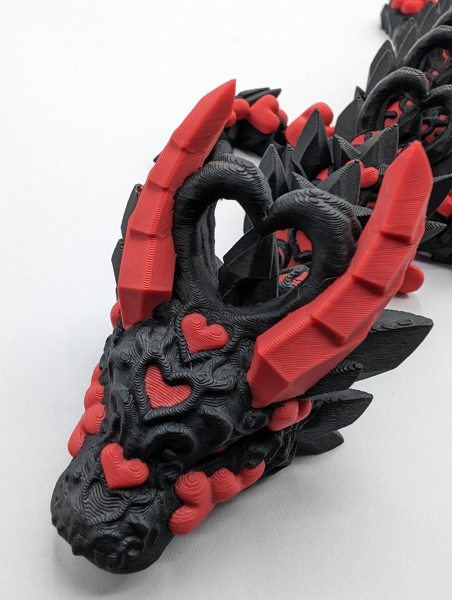 Discover the magic of our Valentine Heart Dragon! This enchanting articulating dragon not only graces your bookshelf with whimsy but also makes for a heartfelt and unforgettable Valentine's Day gift. Elevate your space with love!