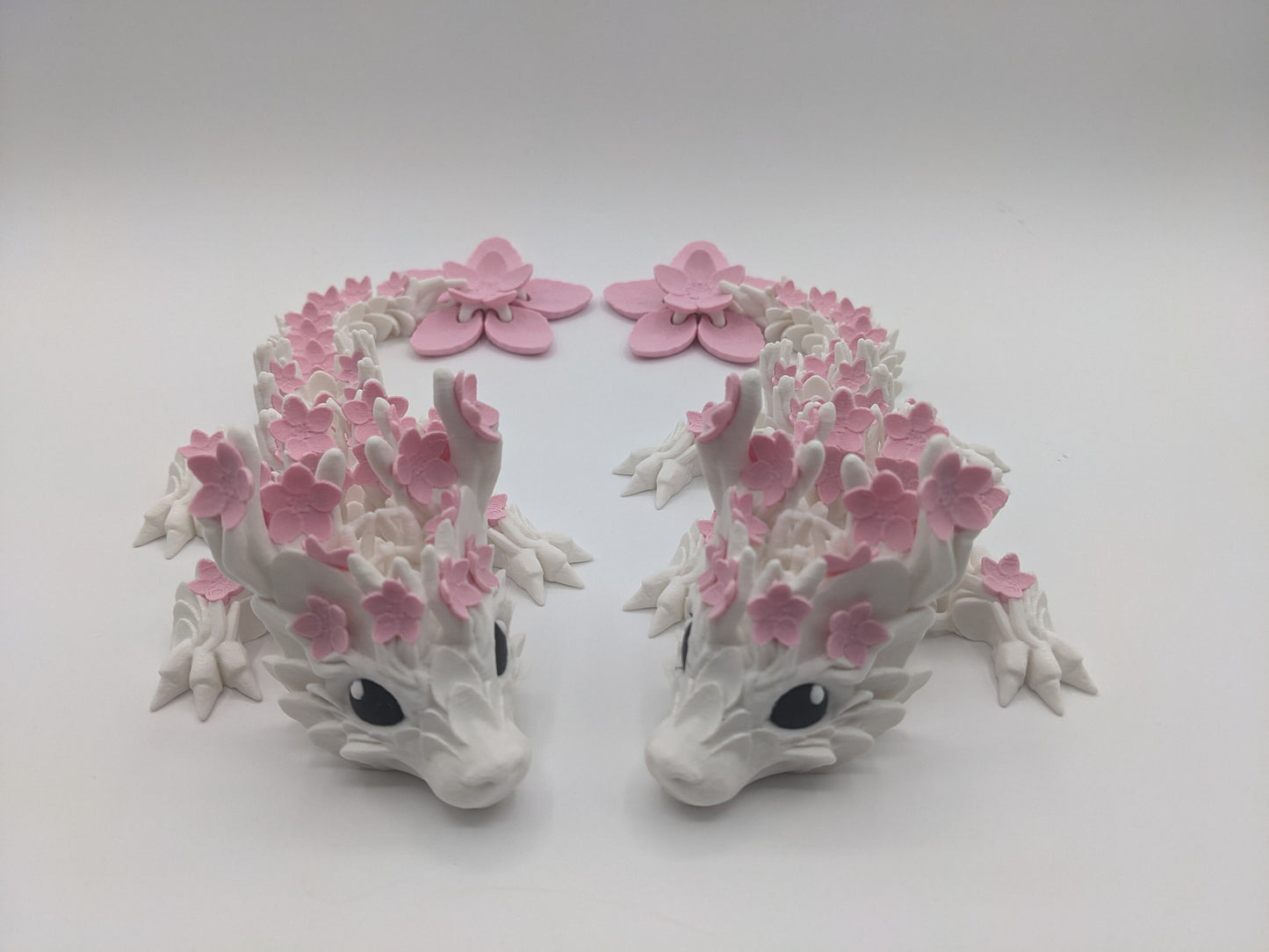 Introducing our Beautiful Articulated Baby Blossom Dragon Fidget Toy, a charming and playful addition to your collection.