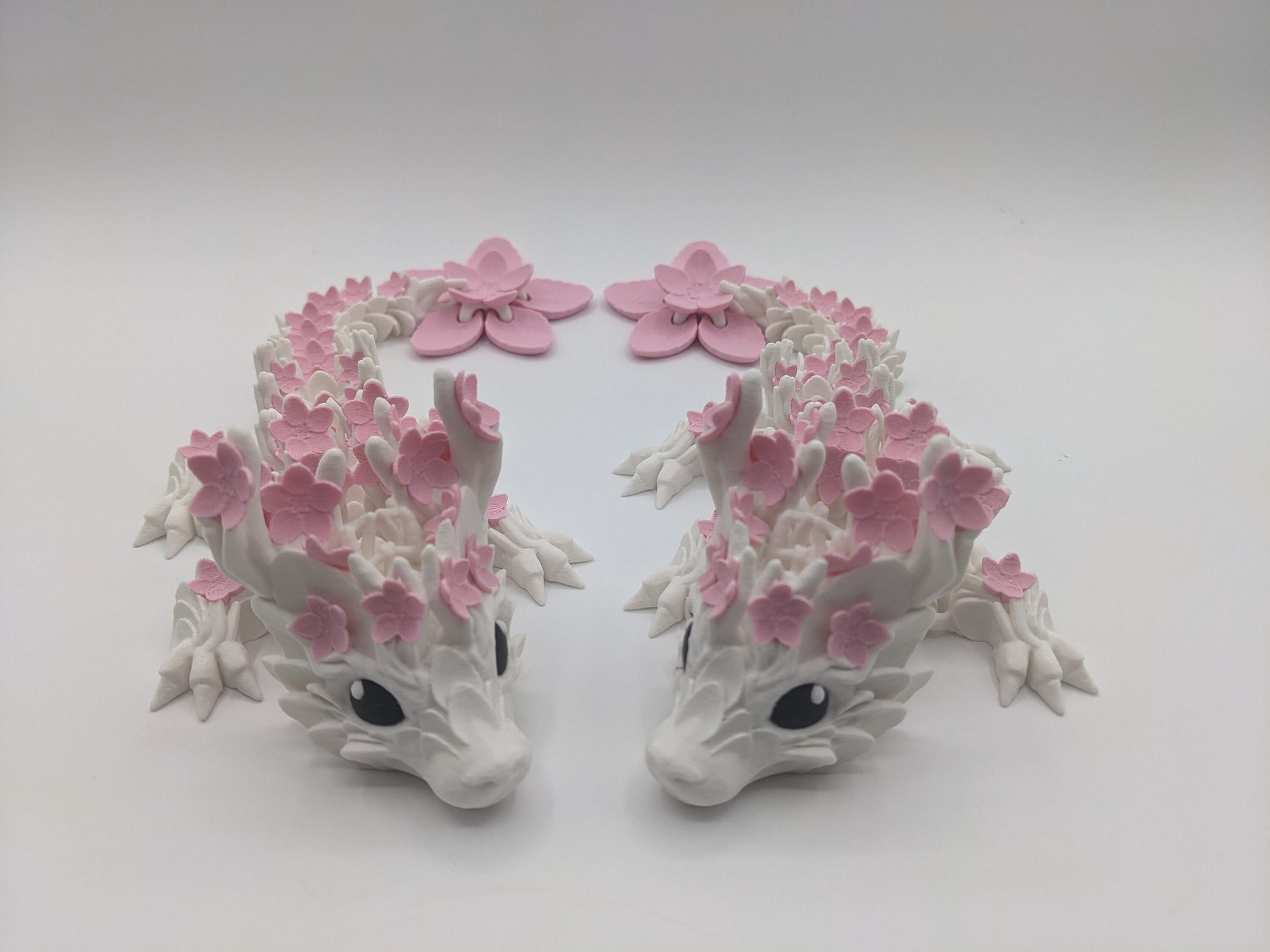 Introducing our Beautiful Articulated Baby Blossom Dragon Fidget Toy, a charming and playful addition to your collection.