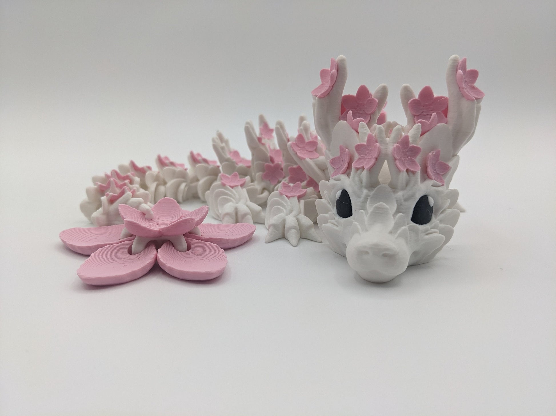 Introducing our Beautiful Articulated Baby Blossom Dragon Fidget Toy, a charming and playful addition to your collection.