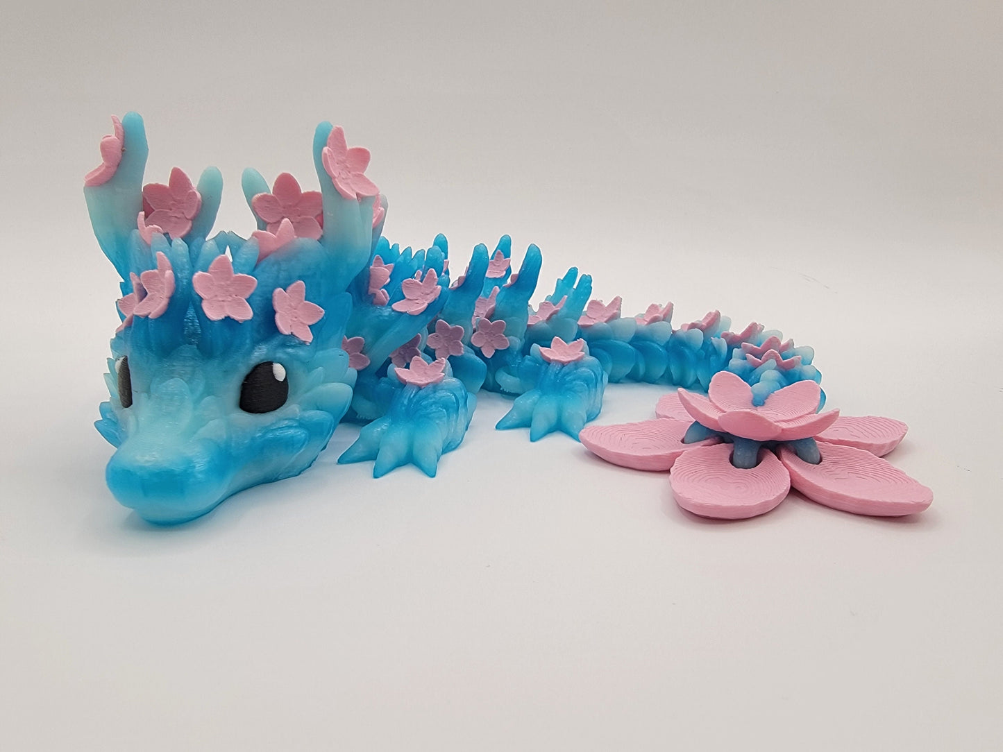 Introducing our Beautiful Articulated Baby Blossom Dragon Fidget Toy, a charming and playful addition to your collection.