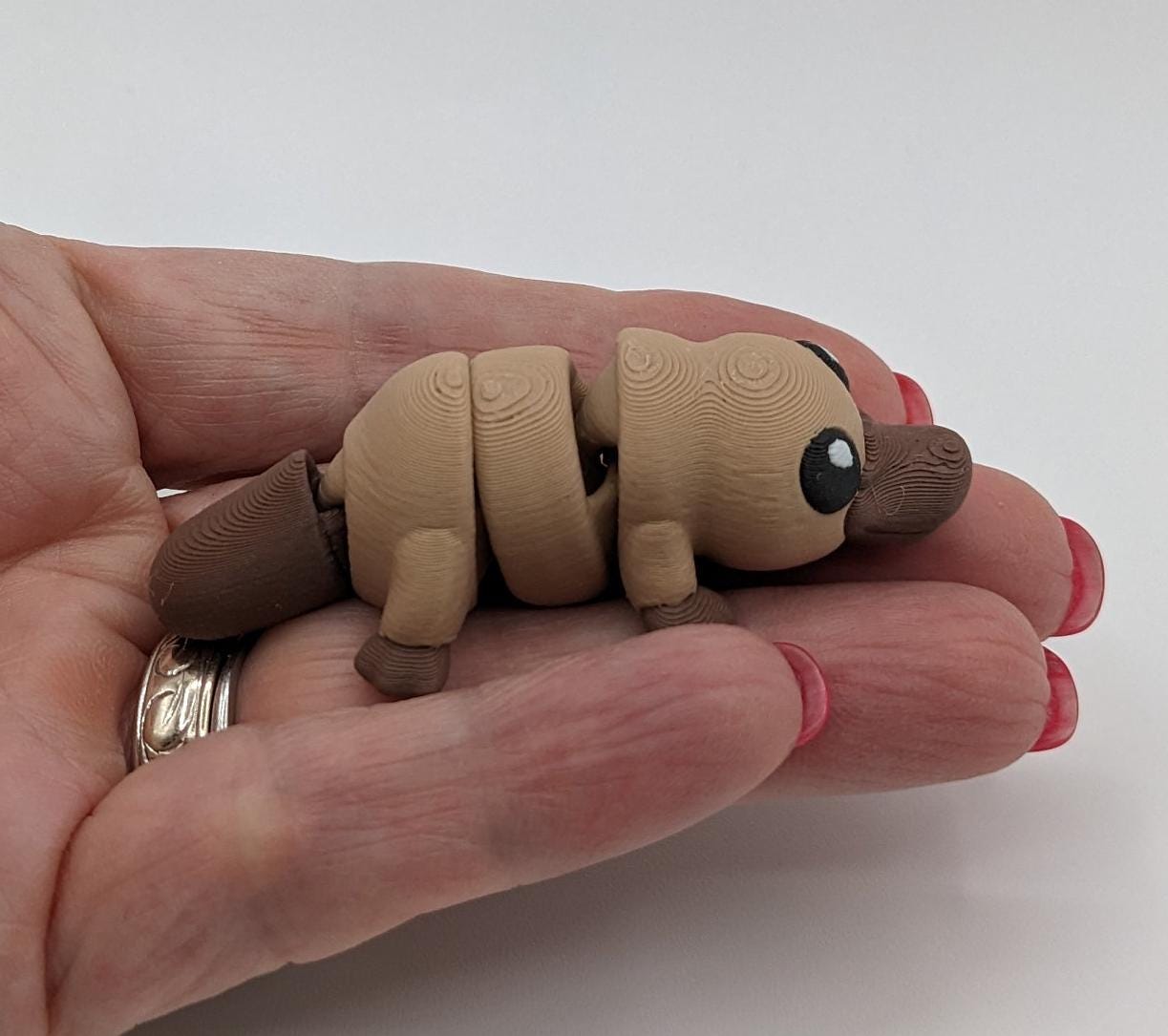 This charming Baby Platypus fidget toy is meticulously designed to fit comfortably in your hand, making it an ideal stress-relief companion. The tactile satisfaction and whimsical design make it a must-have for fidgeters of all ages.