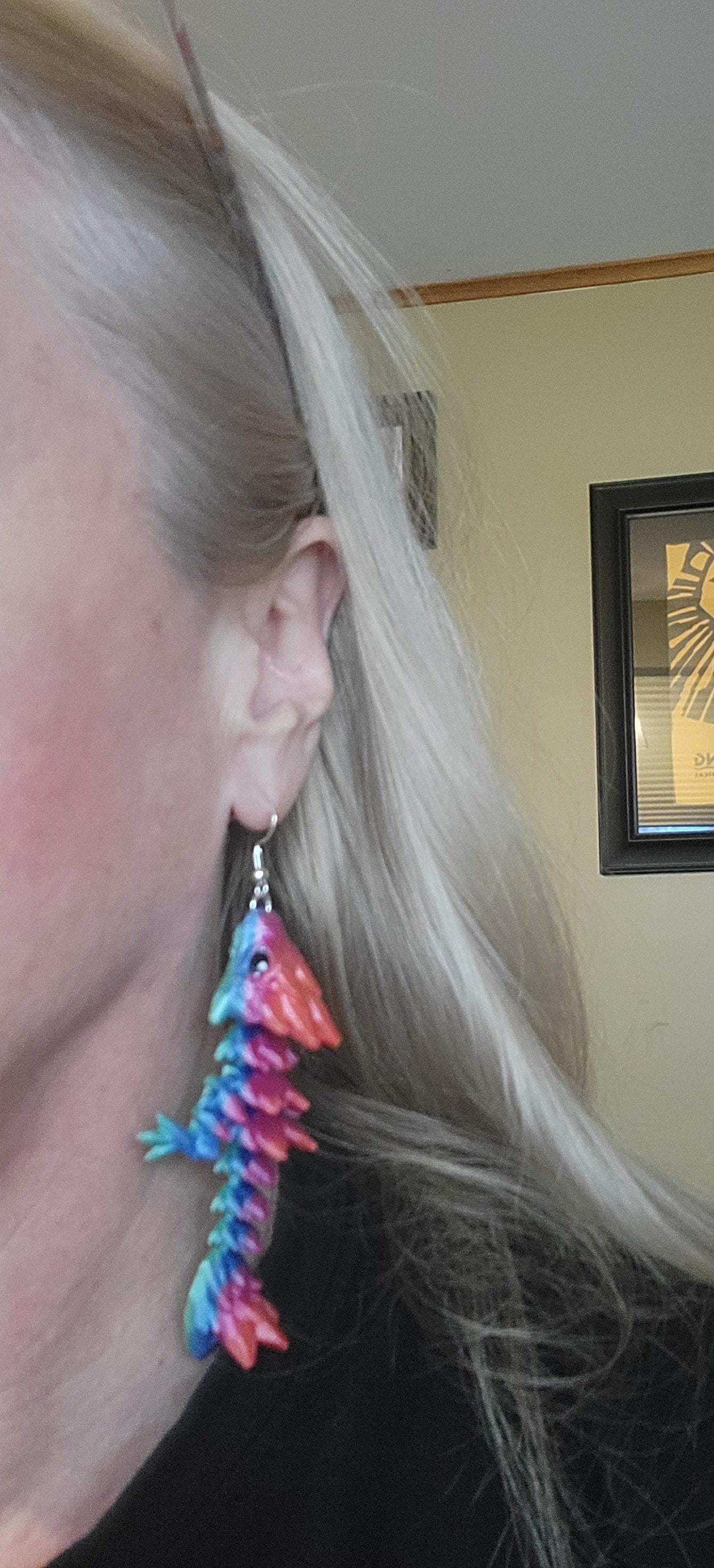 Handcrafted with exquisite detail, these enchanting earrings are the perfect blend of fantasy and elegance, designed to add a touch of whimsy to any outfit. The baby dragon is articulated and moveable.