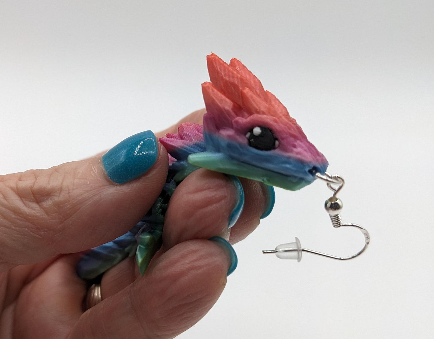 Handcrafted with exquisite detail, these enchanting earrings are the perfect blend of fantasy and elegance, designed to add a touch of whimsy to any outfit. The baby dragon is articulated and moveable.