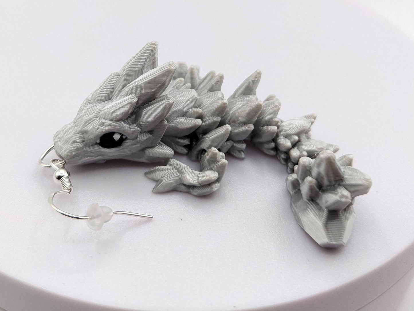 Handcrafted with exquisite detail, these enchanting earrings are the perfect blend of fantasy and elegance, designed to add a touch of whimsy to any outfit. The baby dragon is articulated and moveable.