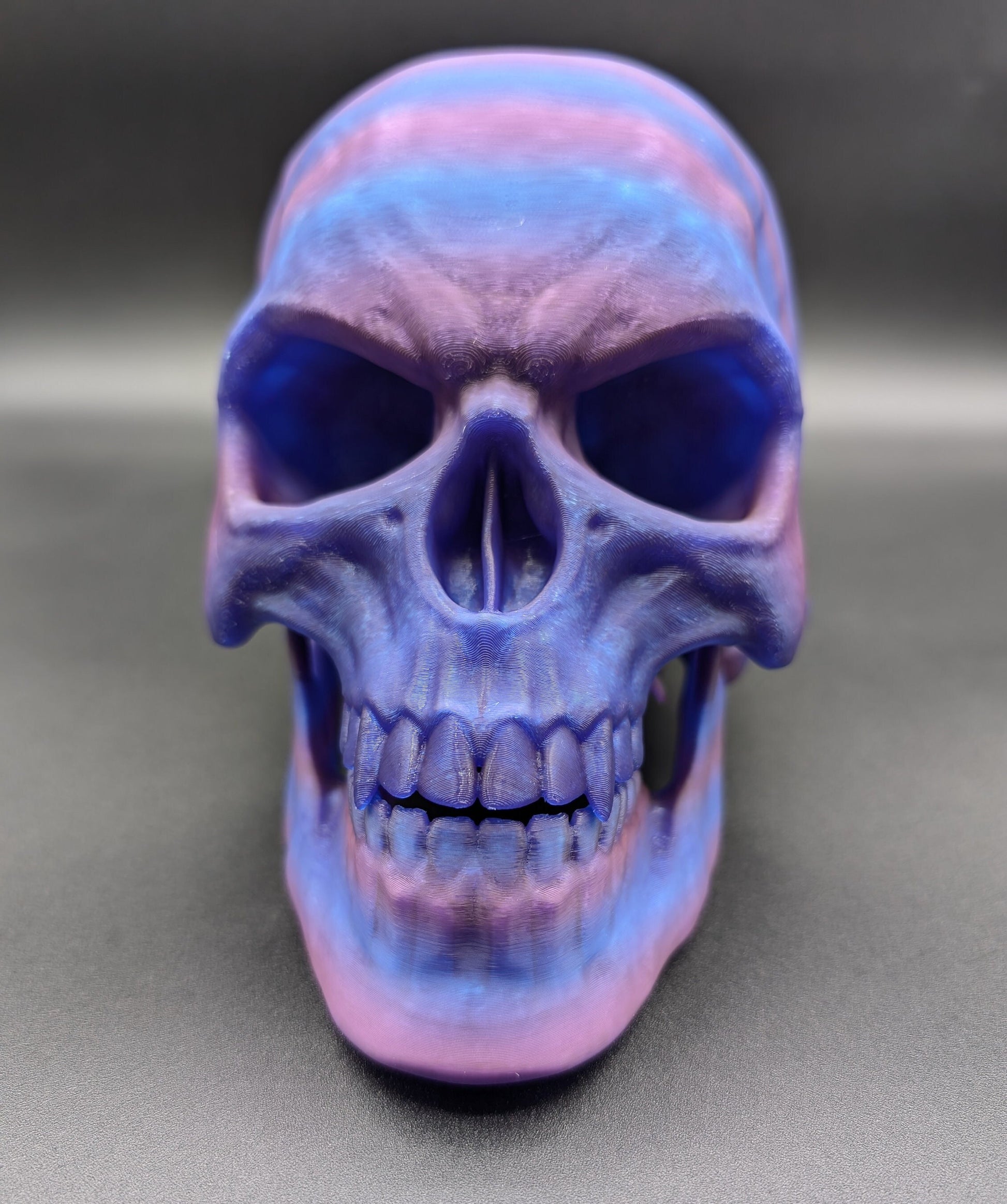 Introducing our Articulated Halloween Vampire Human Skull, the perfect addition to your Halloween decor or gothic collection. This intricately designed skull is a fun and interactive item, thanks to its fully articulated jaw. Multiple colors offered!