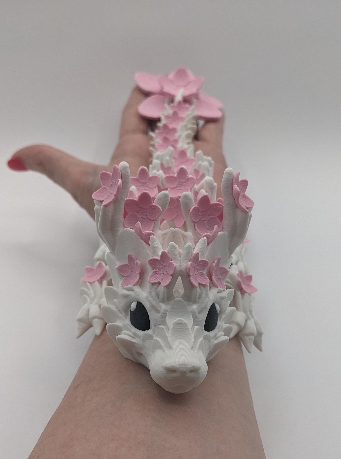 Introducing our Beautiful Articulated Baby Blossom Dragon Fidget Toy, a charming and playful addition to your collection.