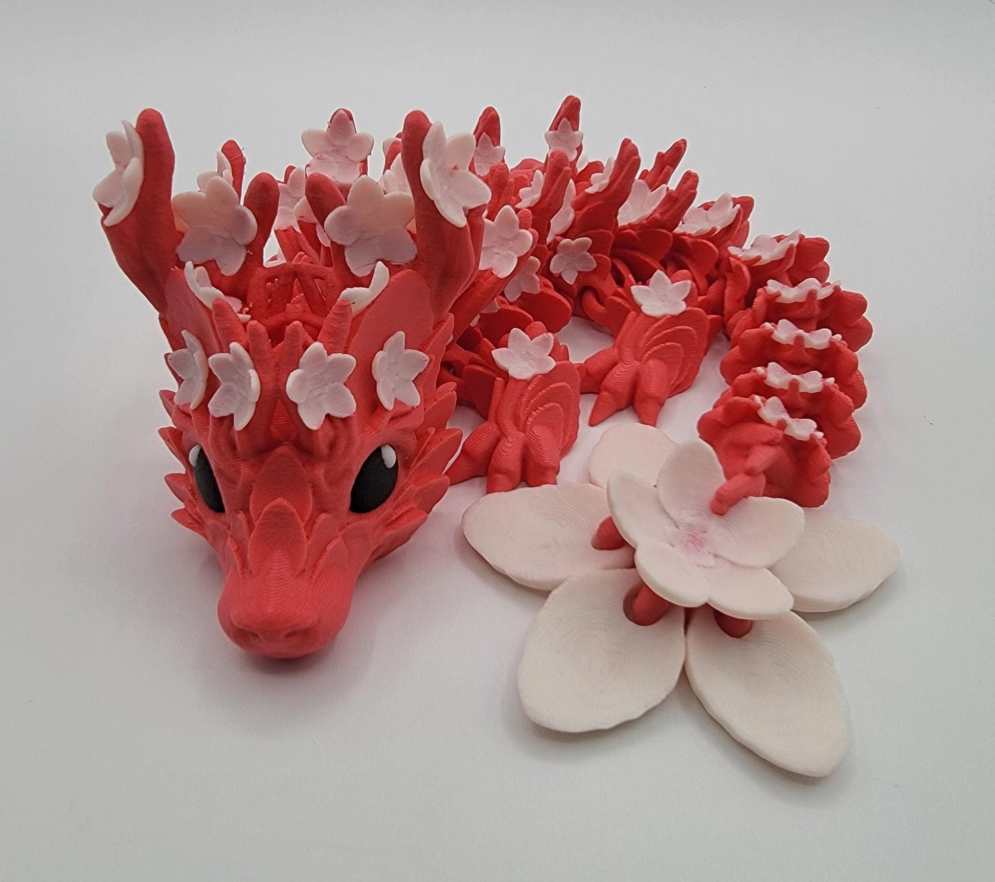 Introducing our Beautiful Articulated Baby Blossom Dragon Fidget Toy, a charming and playful addition to your collection.