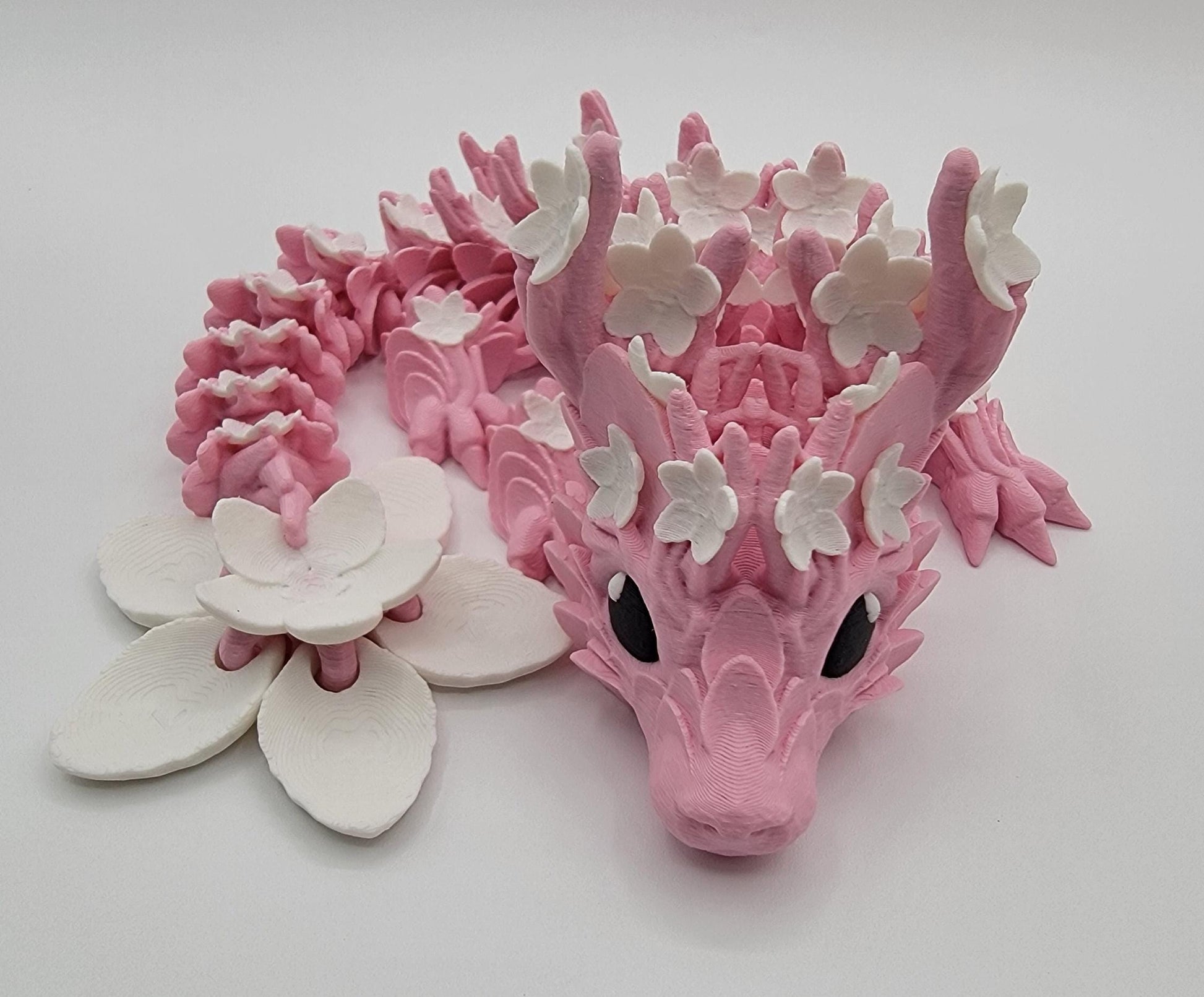 Introducing our Beautiful Articulated Baby Blossom Dragon Fidget Toy, a charming and playful addition to your collection.