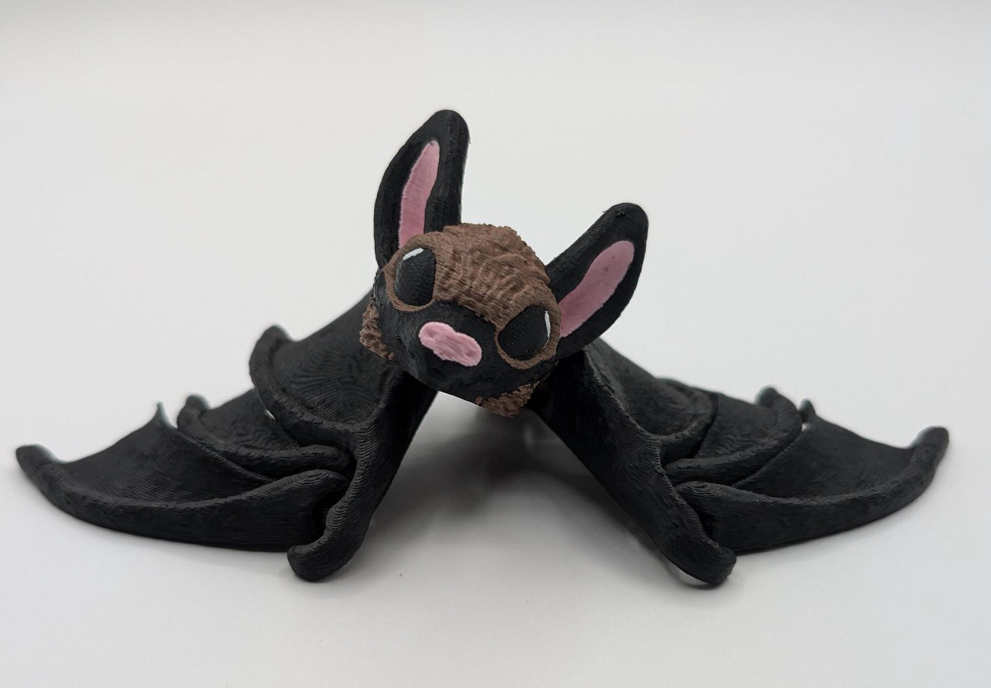 Our Adorable Articulating Bat features fully movable wings & joints, allowing for fun posing & display! Add playful yet spooky presence to any setting.