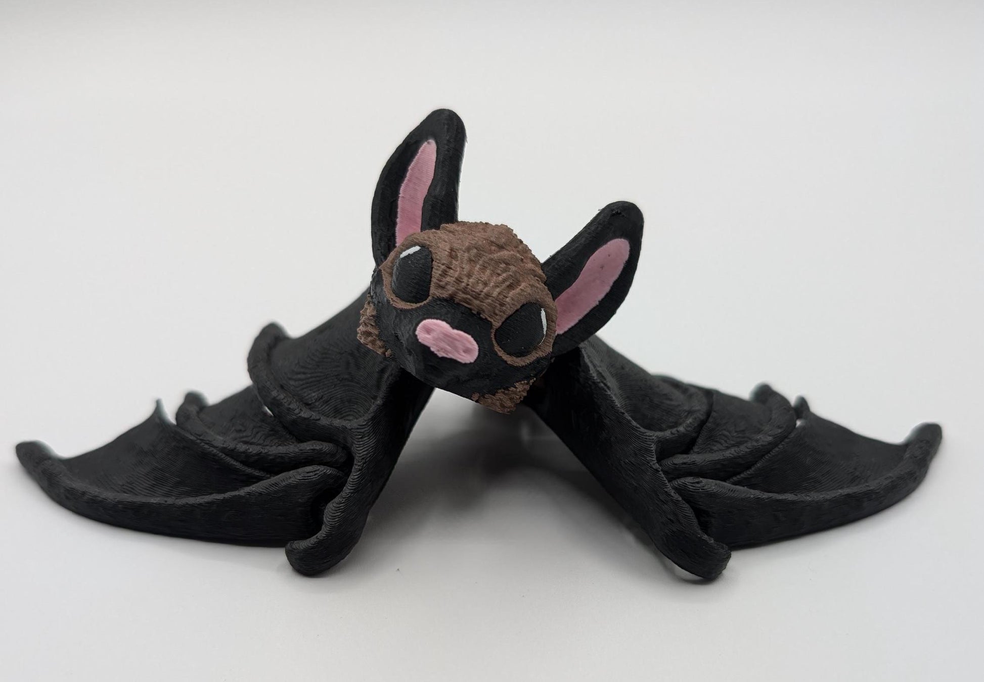 Our Adorable Articulating Bat features fully movable wings & joints, allowing for fun posing & display! Add playful yet spooky presence to any setting.
