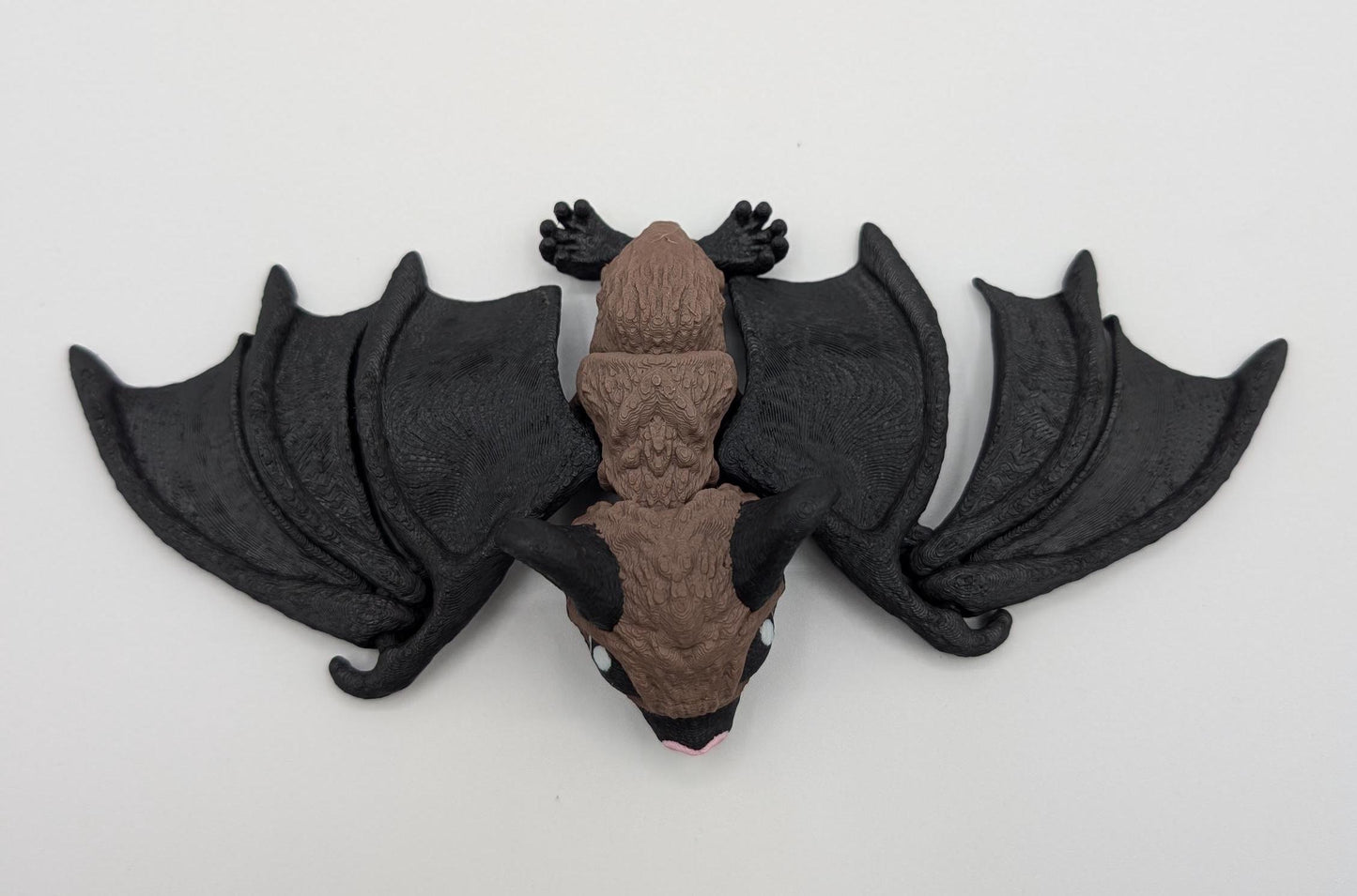Our Adorable Articulating Bat features fully movable wings & joints, allowing for fun posing & display! Add playful yet spooky presence to any setting.