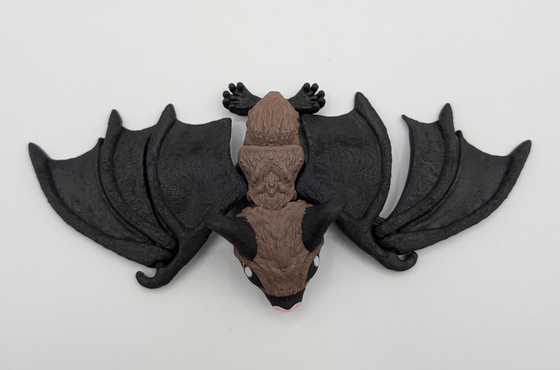 Our Adorable Articulating Bat features fully movable wings & joints, allowing for fun posing & display! Add playful yet spooky presence to any setting.