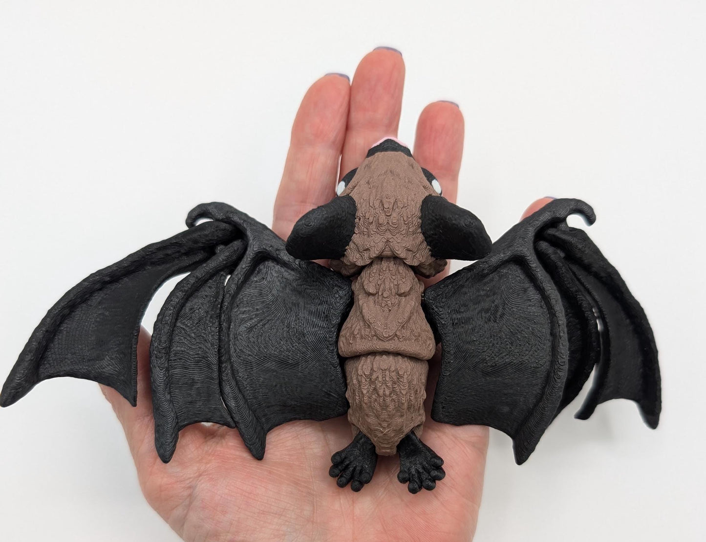 Our Adorable Articulating Bat features fully movable wings & joints, allowing for fun posing & display! Add playful yet spooky presence to any setting.