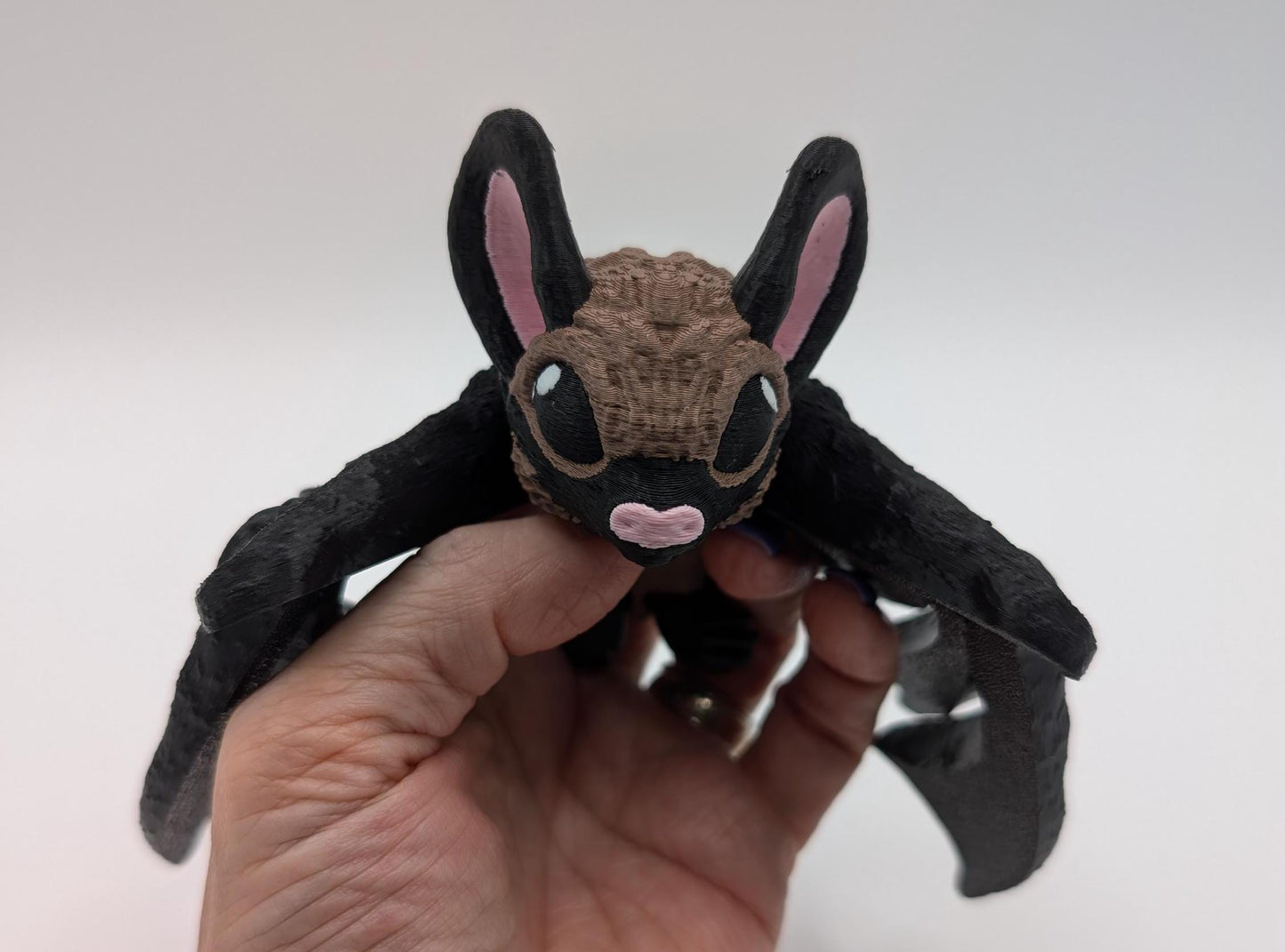 Our Adorable Articulating Bat features fully movable wings & joints, allowing for fun posing & display! Add playful yet spooky presence to any setting.