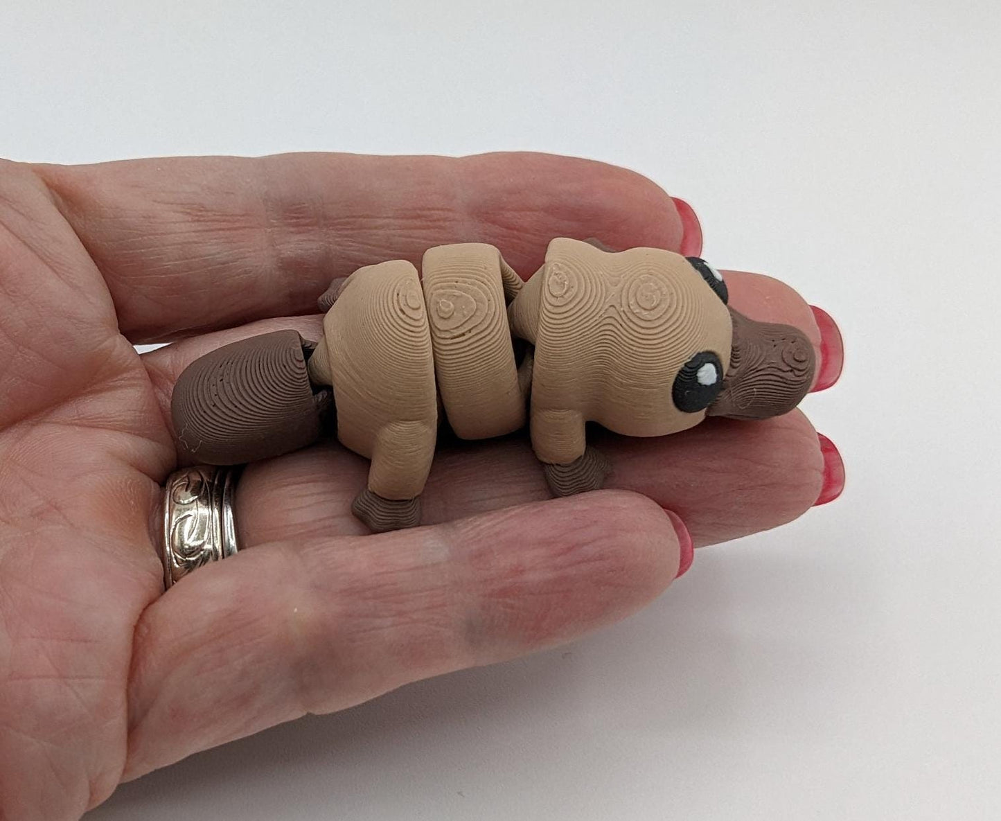 This charming Baby Platypus fidget toy is meticulously designed to fit comfortably in your hand, making it an ideal stress-relief companion. The tactile satisfaction and whimsical design make it a must-have for fidgeters of all ages.