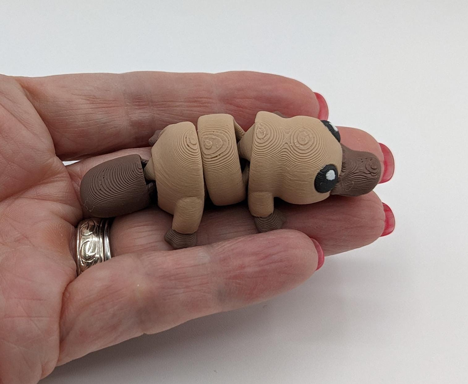 This charming Baby Platypus fidget toy is meticulously designed to fit comfortably in your hand, making it an ideal stress-relief companion. The tactile satisfaction and whimsical design make it a must-have for fidgeters of all ages.