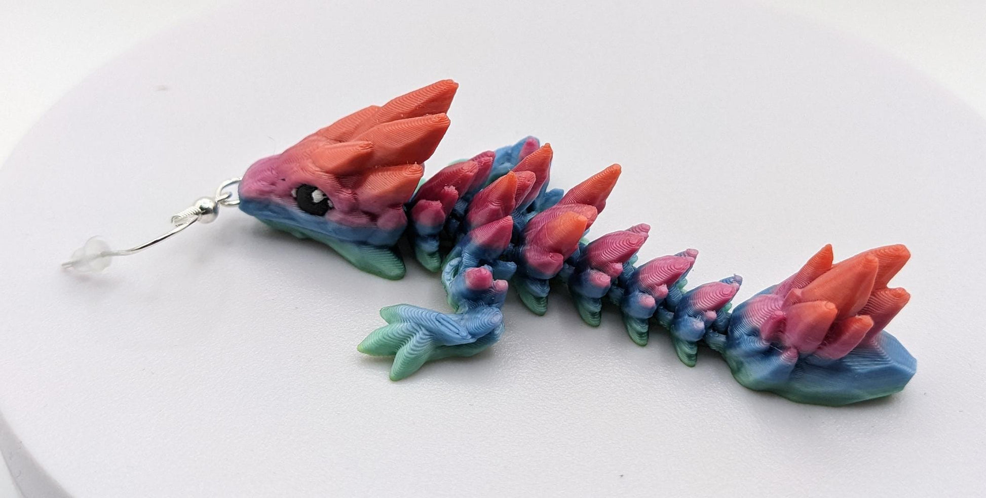Handcrafted with exquisite detail, these enchanting earrings are the perfect blend of fantasy and elegance, designed to add a touch of whimsy to any outfit. The baby dragon is articulated and moveable.