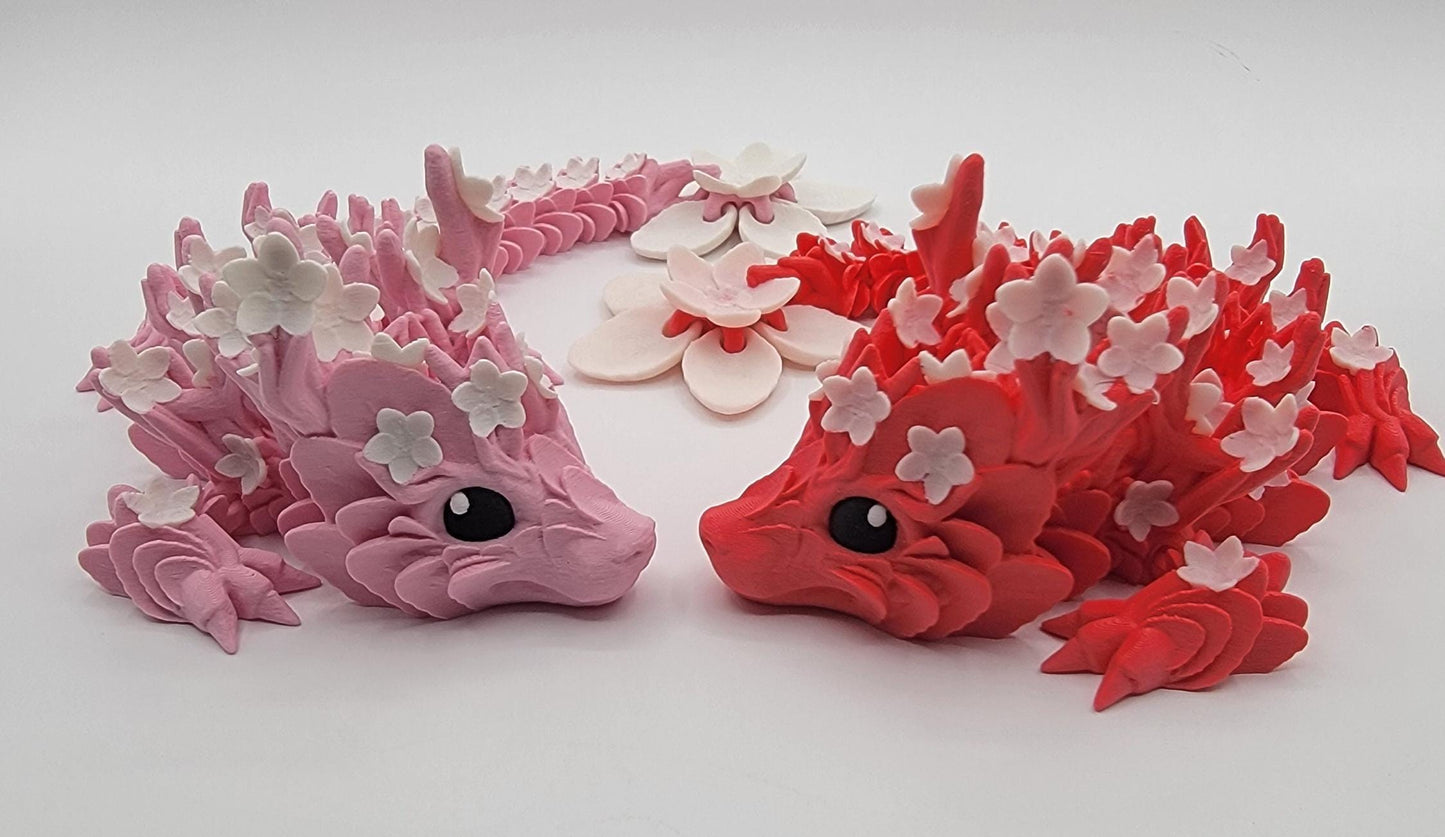 Introducing our Beautiful Articulated Baby Blossom Dragon Fidget Toy, a charming and playful addition to your collection.