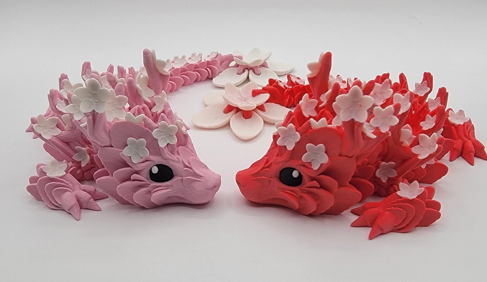 Introducing our Beautiful Articulated Baby Blossom Dragon Fidget Toy, a charming and playful addition to your collection.