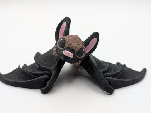 Our Adorable Articulating Bat features fully movable wings & joints, allowing for fun posing & display! Add playful yet spooky presence to any setting.