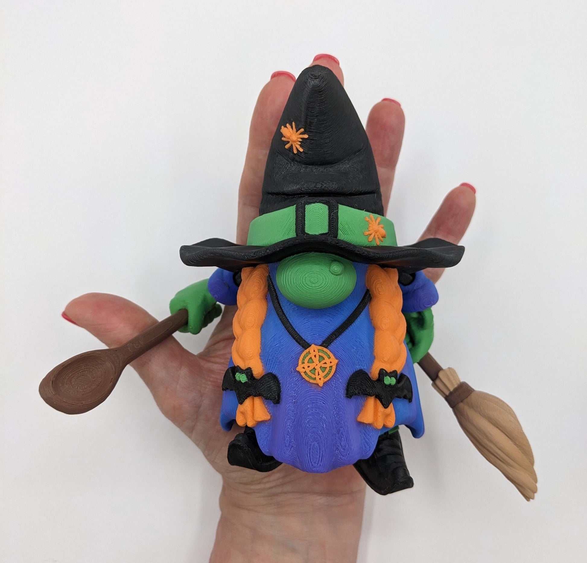 Meet our Articulated Halloween Witch Gnome with Cauldron, Broom, & Spoon! This delightful gnome brings whimsical magic to your seasonal decor. Perfect for Halloween enthusiasts and collectors, this piece is sure to add a playful charm to any setting.