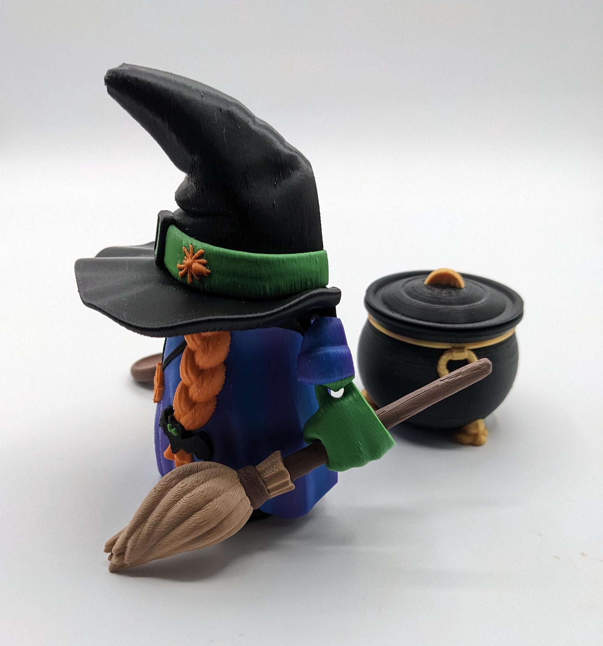 Meet our Articulated Halloween Witch Gnome with Cauldron, Broom, & Spoon! This delightful gnome brings whimsical magic to your seasonal decor. Perfect for Halloween enthusiasts and collectors, this piece is sure to add a playful charm to any setting.