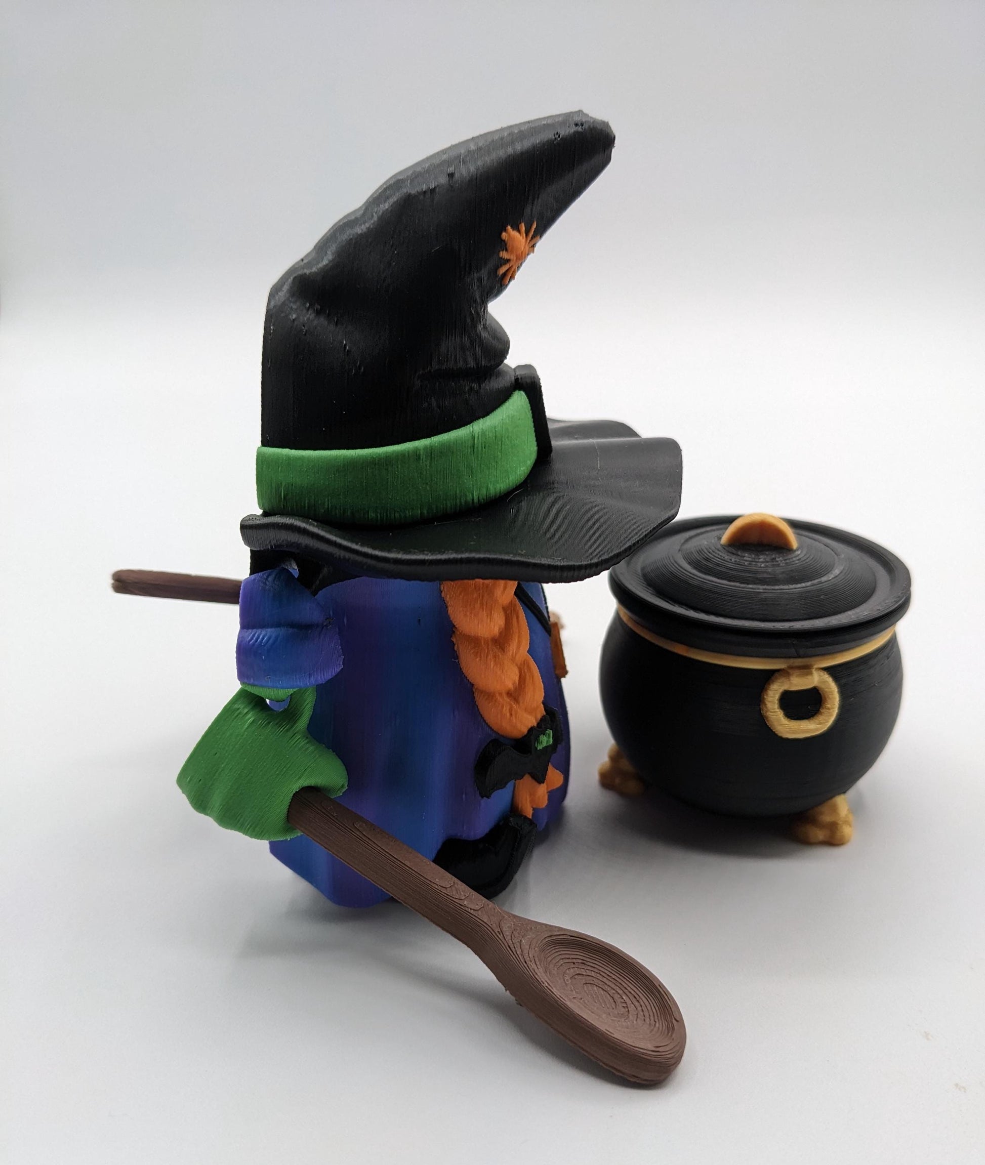 Meet our Articulated Halloween Witch Gnome with Cauldron, Broom, & Spoon! This delightful gnome brings whimsical magic to your seasonal decor. Perfect for Halloween enthusiasts and collectors, this piece is sure to add a playful charm to any setting.
