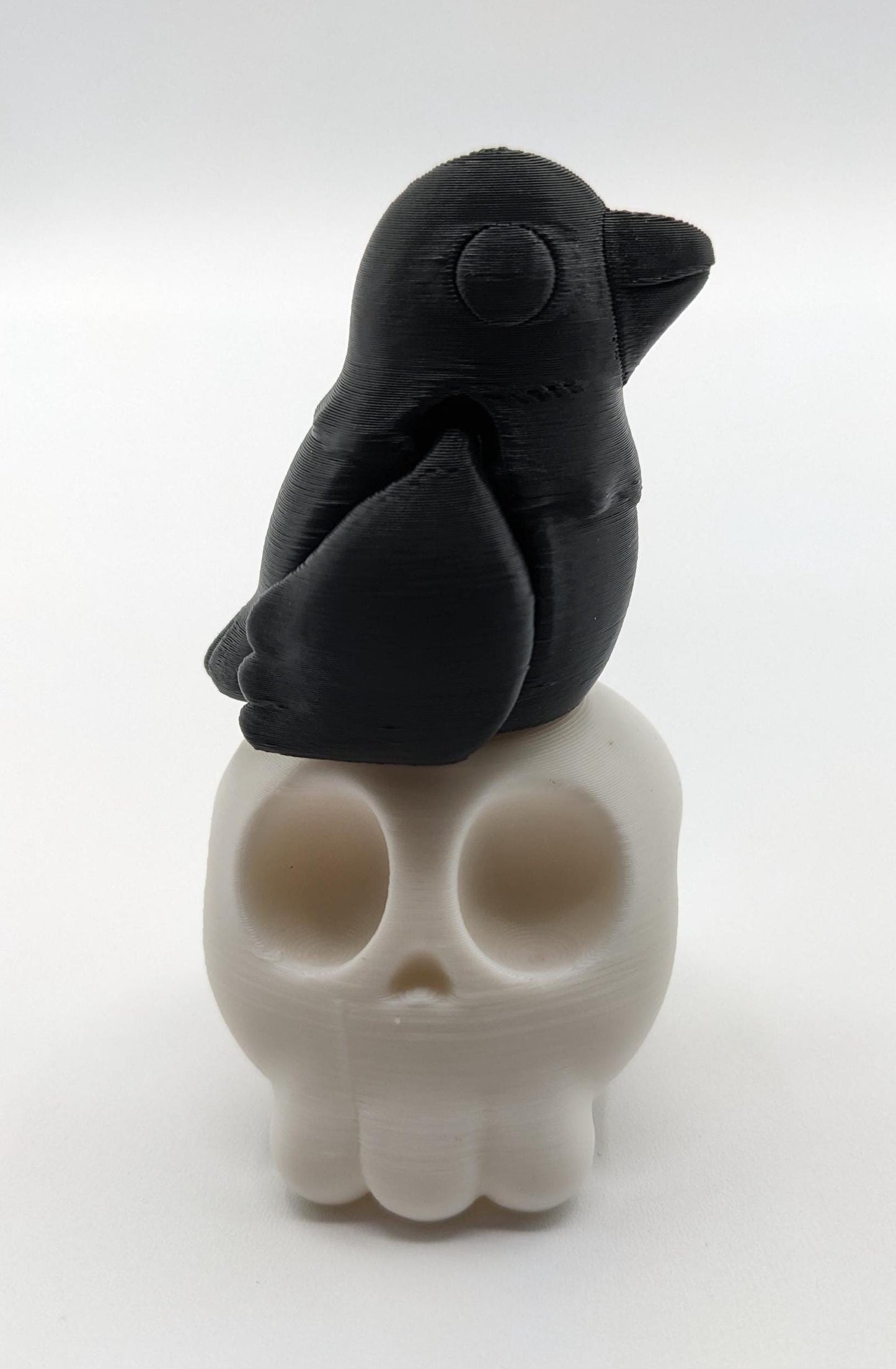 Our Poe Crow on a Skull features a meticulously crafted articulated crow perched on a skull, embodying the perfect blend of mystery and sophistication. Ideal for Halloween or year-round Gothic decor, it's sure to become a conversation starter.