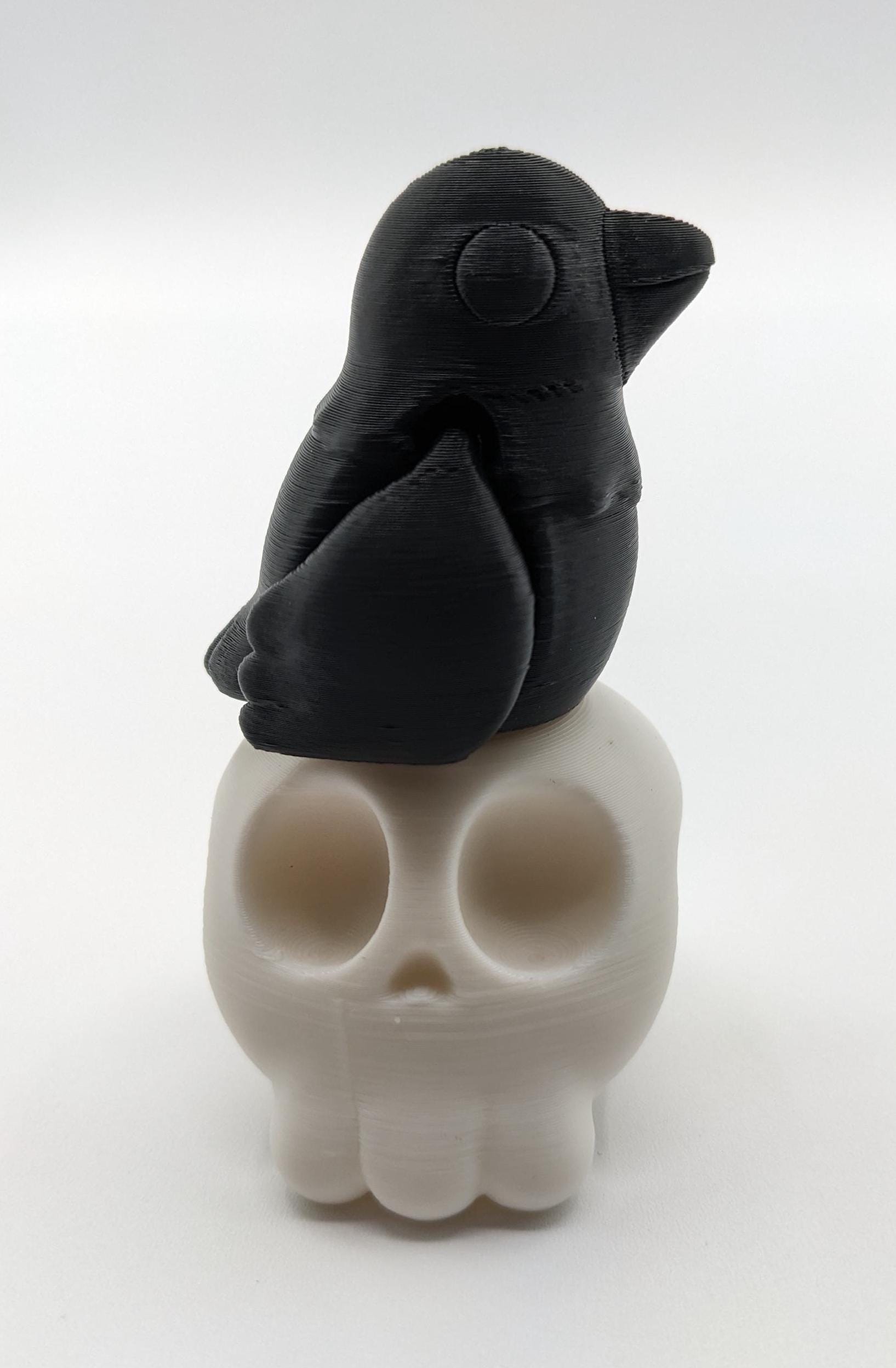 Our Poe Crow on a Skull features a meticulously crafted articulated crow perched on a skull, embodying the perfect blend of mystery and sophistication. Ideal for Halloween or year-round Gothic decor, it's sure to become a conversation starter.