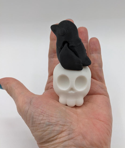 Our Poe Crow on a Skull features a meticulously crafted articulated crow perched on a skull, embodying the perfect blend of mystery and sophistication. Ideal for Halloween or year-round Gothic decor, it's sure to become a conversation starter.