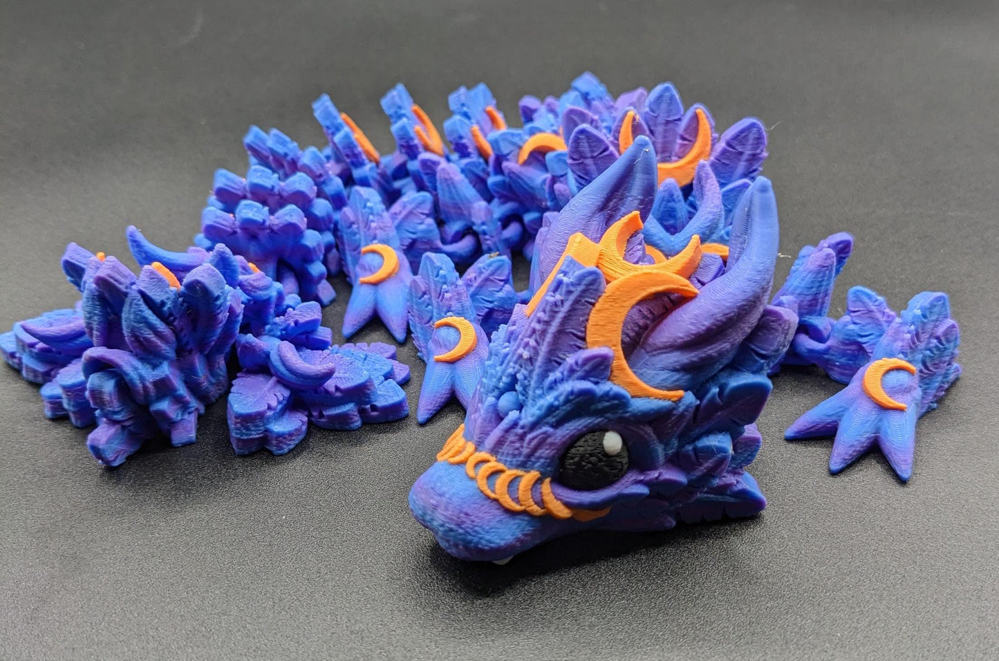 Our Halloween Lunar Dragon will add a touch of lunar magic to your Halloween decor enhancing a playful and mystical appeal. Perfect for adding a whimsical touch to any space, this dragon is sure to delight fans of all ages.