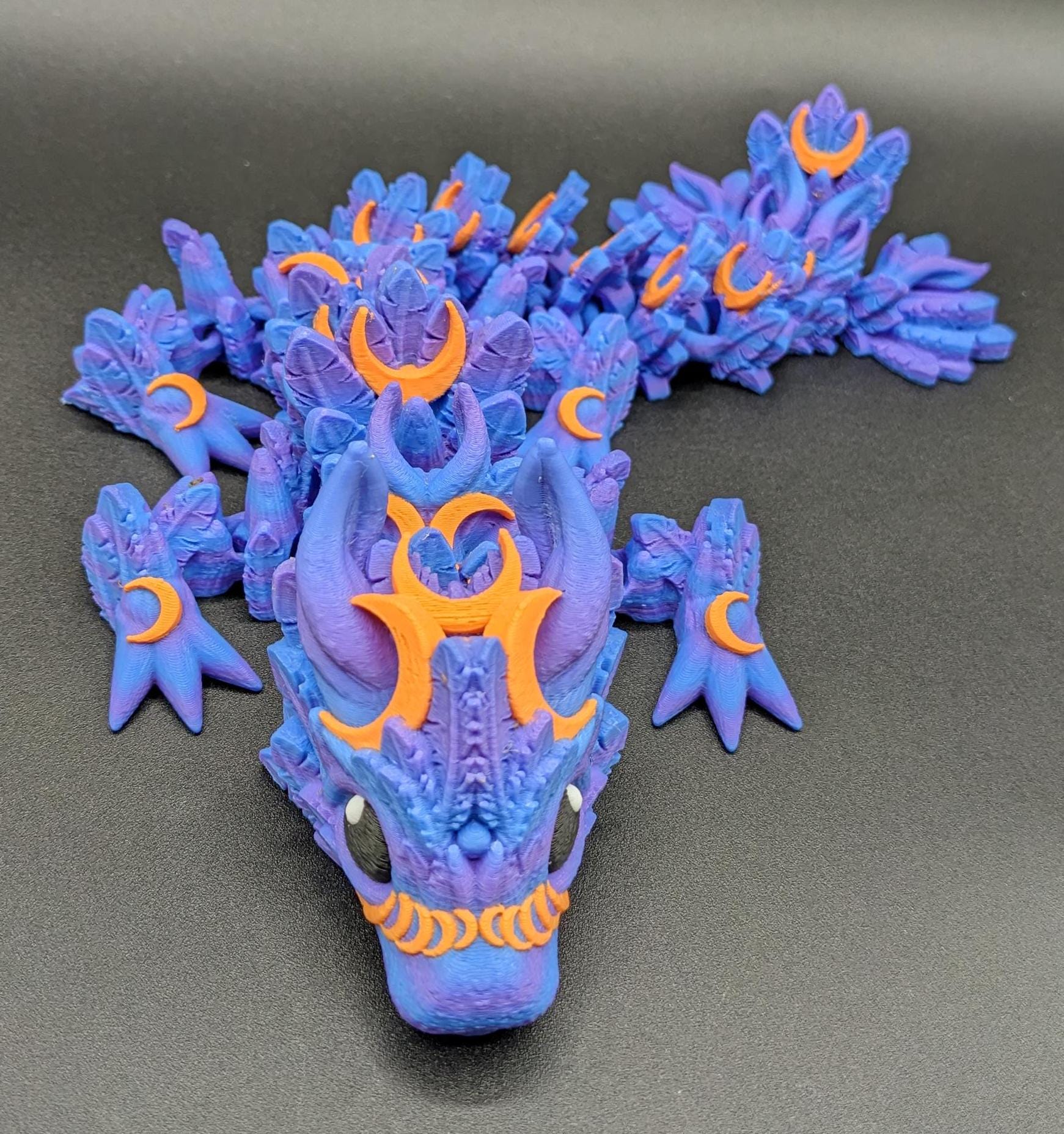 Our Halloween Lunar Dragon will add a touch of lunar magic to your Halloween decor enhancing a playful and mystical appeal. Perfect for adding a whimsical touch to any space, this dragon is sure to delight fans of all ages.