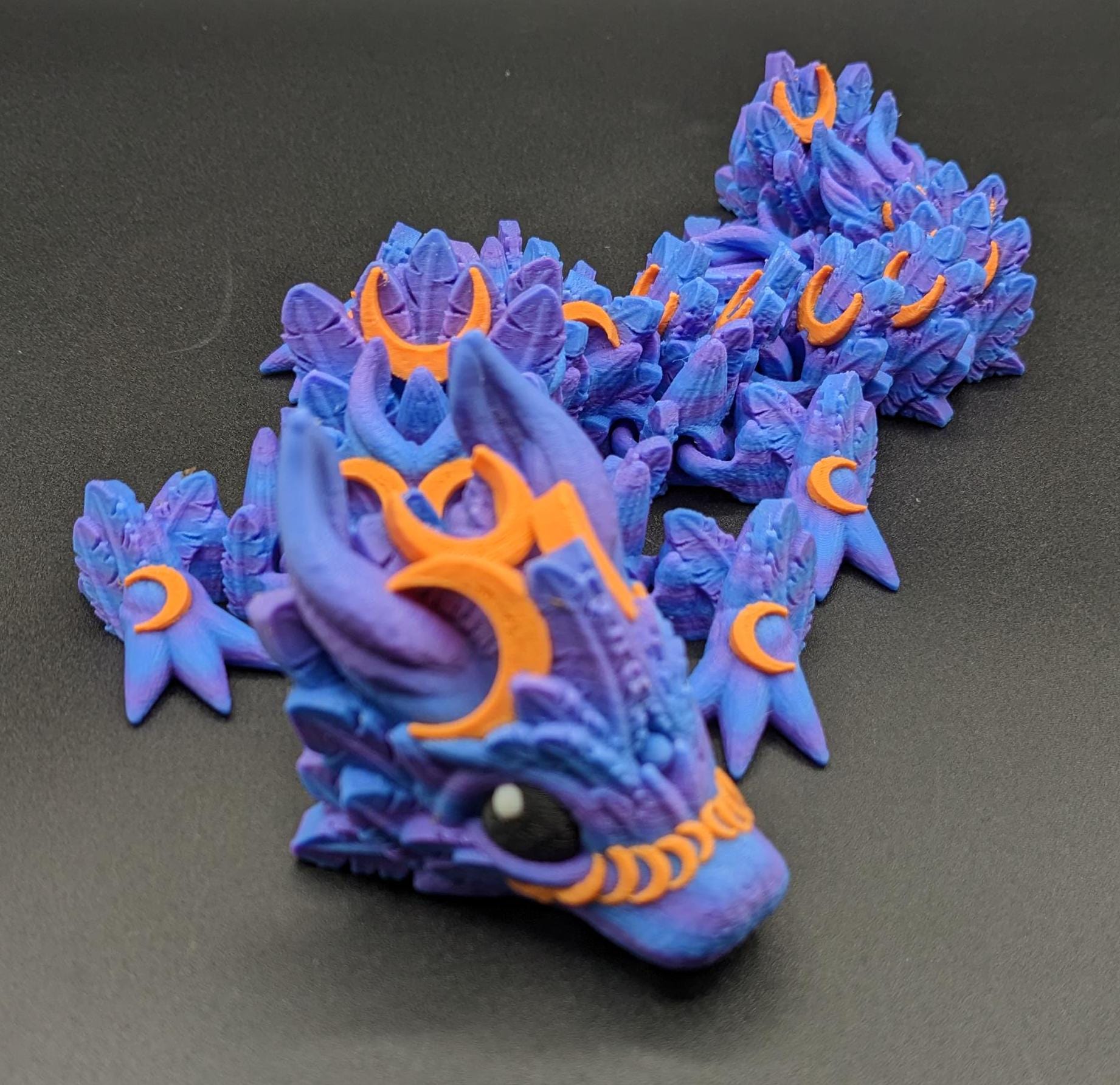 Our Halloween Lunar Dragon will add a touch of lunar magic to your Halloween decor enhancing a playful and mystical appeal. Perfect for adding a whimsical touch to any space, this dragon is sure to delight fans of all ages.