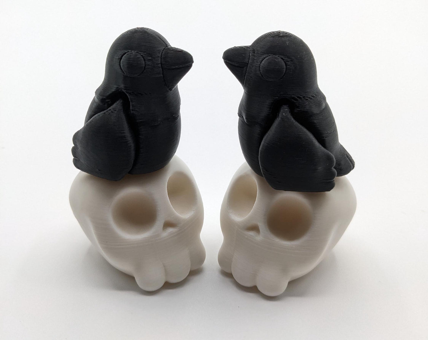 Our Poe Crow on a Skull features a meticulously crafted articulated crow perched on a skull, embodying the perfect blend of mystery and sophistication. Ideal for Halloween or year-round Gothic decor, it's sure to become a conversation starter.