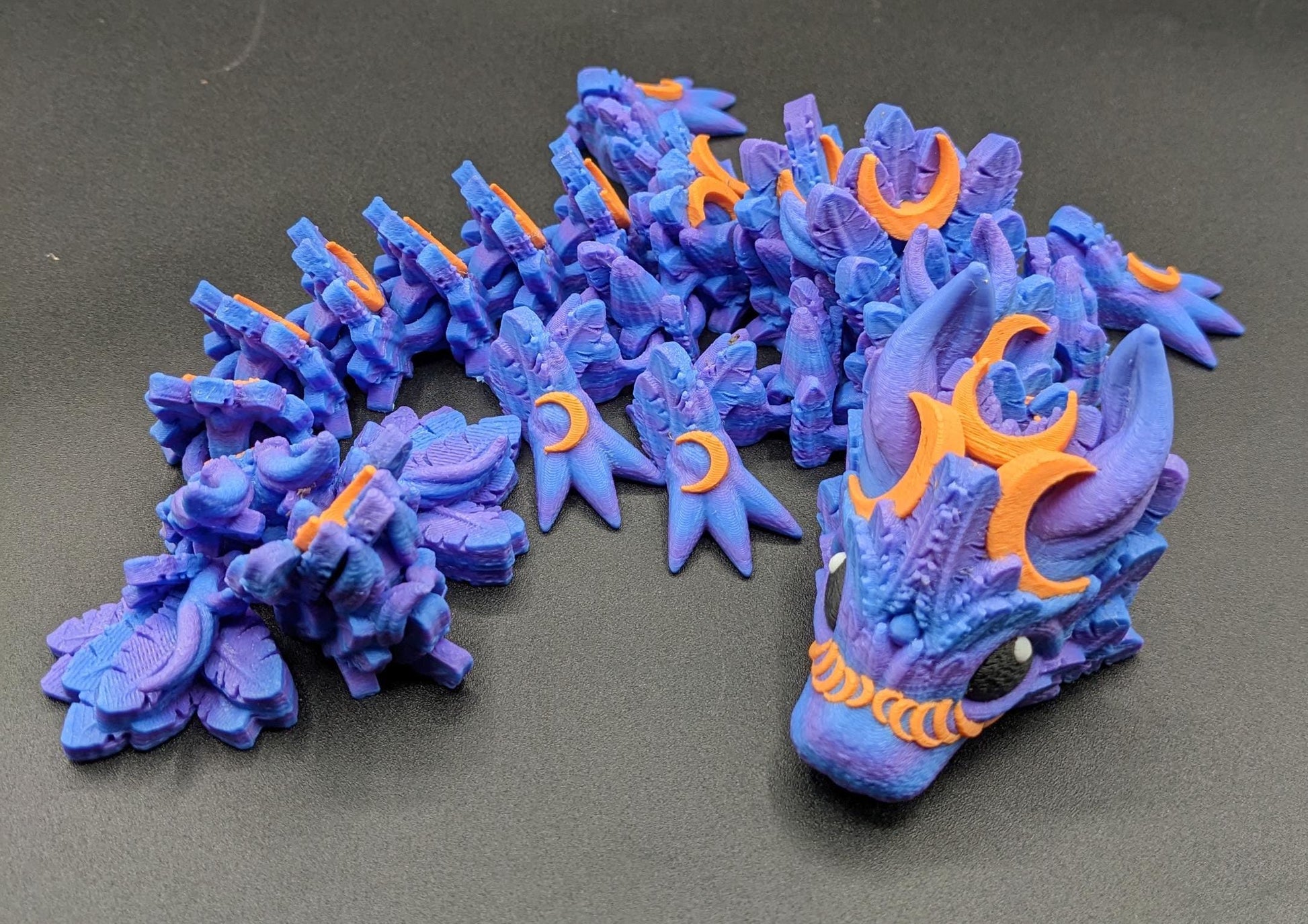 Our Halloween Lunar Dragon will add a touch of lunar magic to your Halloween decor enhancing a playful and mystical appeal. Perfect for adding a whimsical touch to any space, this dragon is sure to delight fans of all ages.