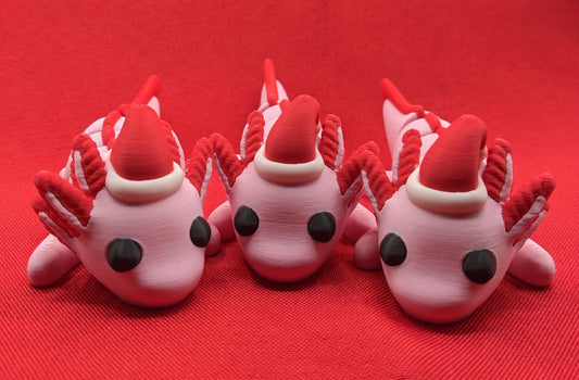 Celebrate the joy of the season with our Articulated Winter Christmas Axolotl Fidget Toy with a cute little Santa hat. This adorable and festive axolotl is perfect for spreading holiday cheer and providing endless fun.