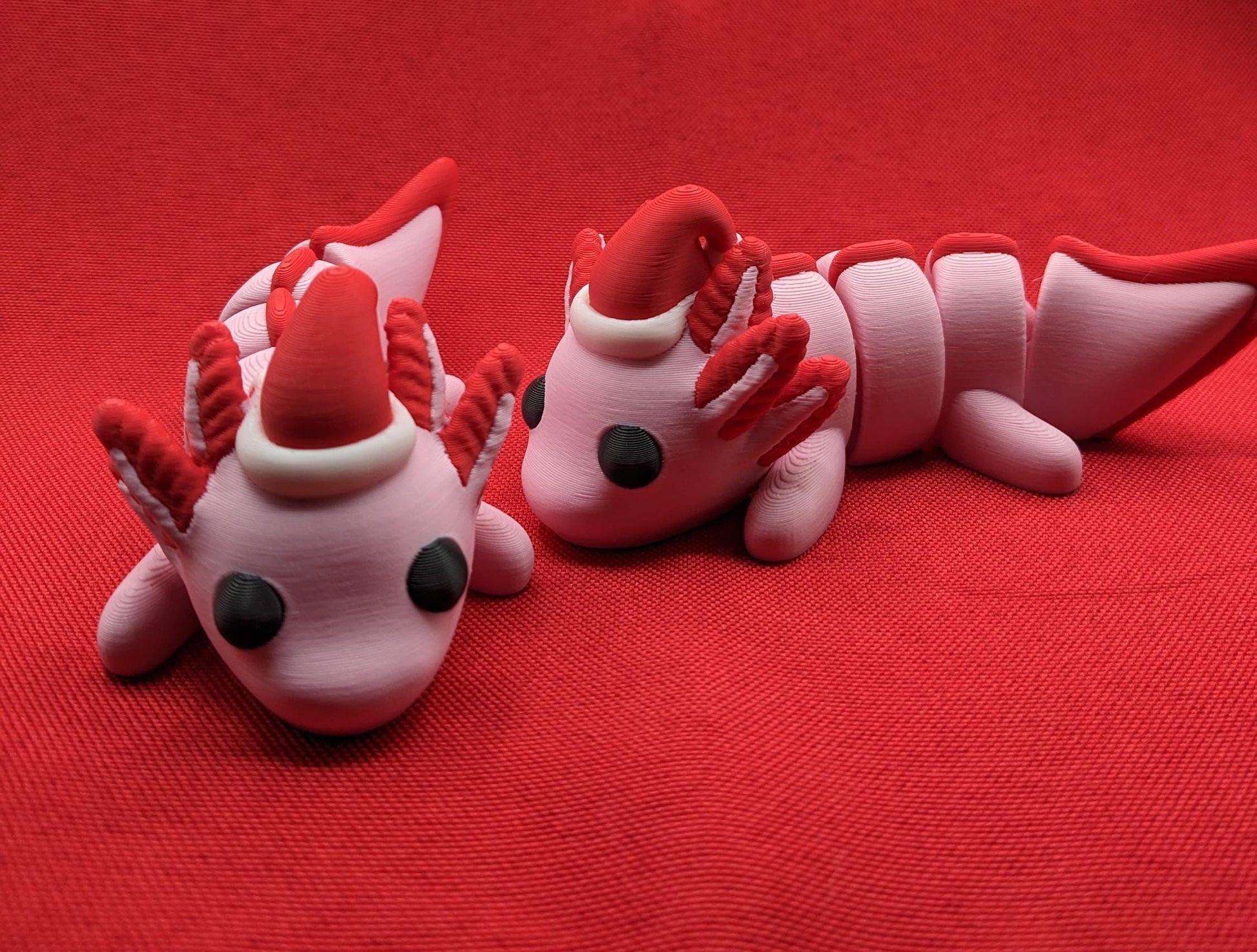 Celebrate the joy of the season with our Articulated Winter Christmas Axolotl Fidget Toy with a cute little Santa hat. This adorable and festive axolotl is perfect for spreading holiday cheer and providing endless fun.