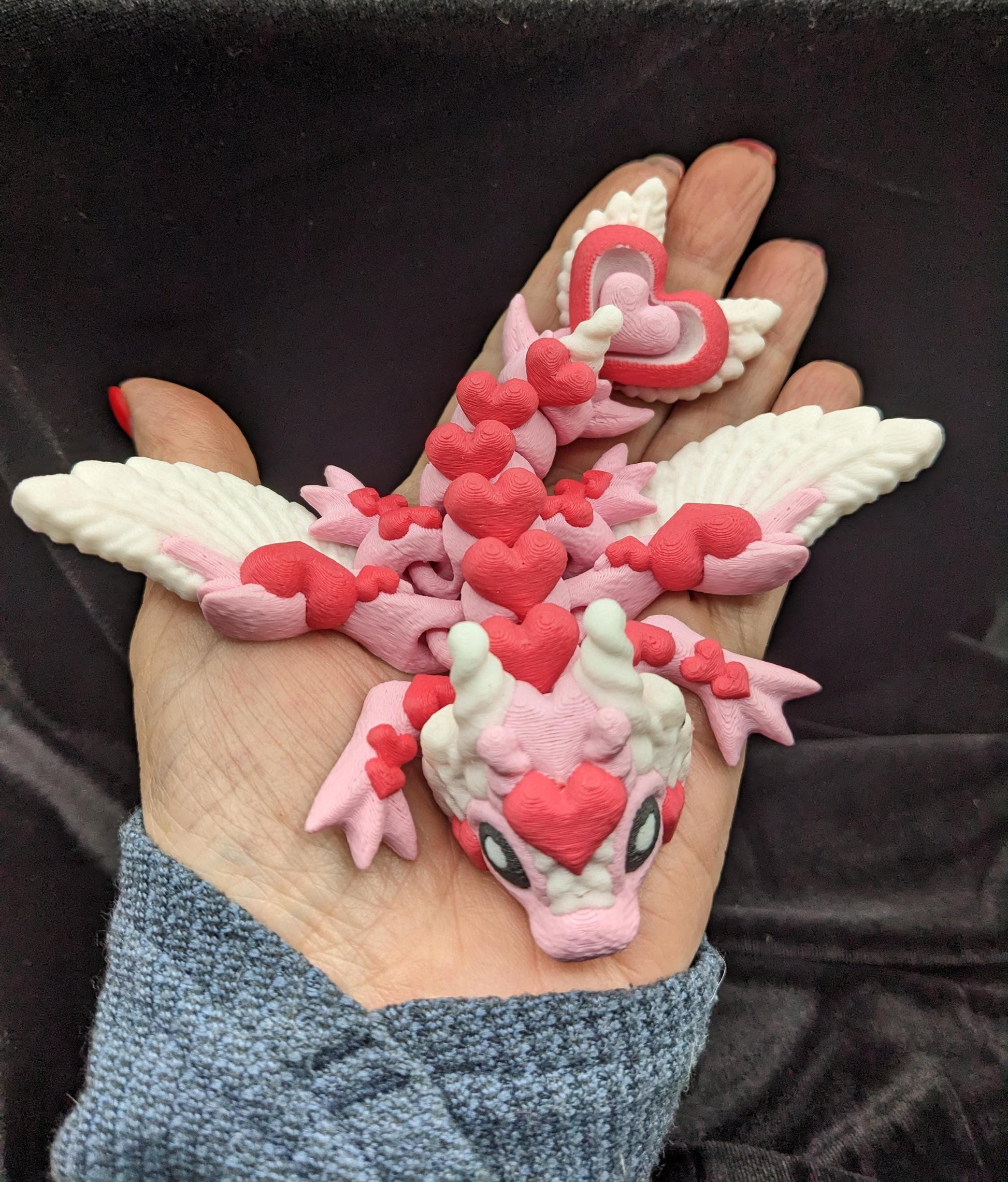 Discover the magic of our Valentine Heart Dragon! This enchanting articulating dragon not only graces your bookshelf with whimsy but also makes for a heartfelt and unforgettable Valentine's Day gift.
