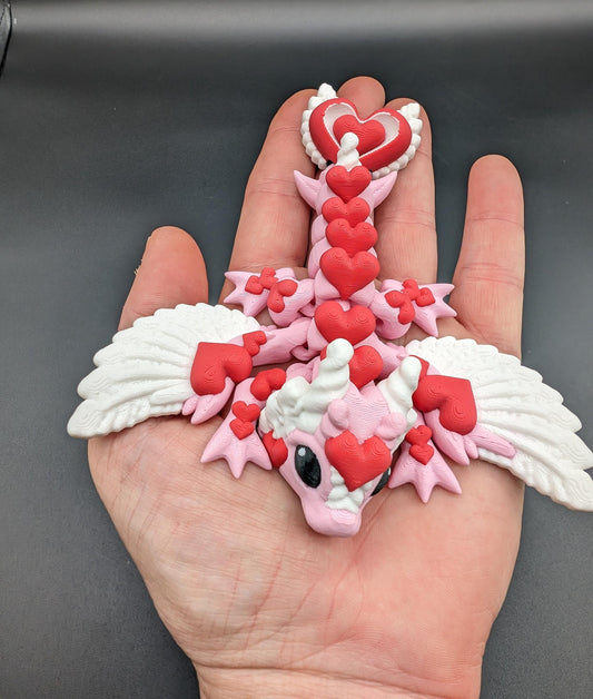 Discover the magic of our Valentine Heart Dragon! This enchanting articulating dragon not only graces your bookshelf with whimsy but also makes for a heartfelt and unforgettable Valentine's Day gift.