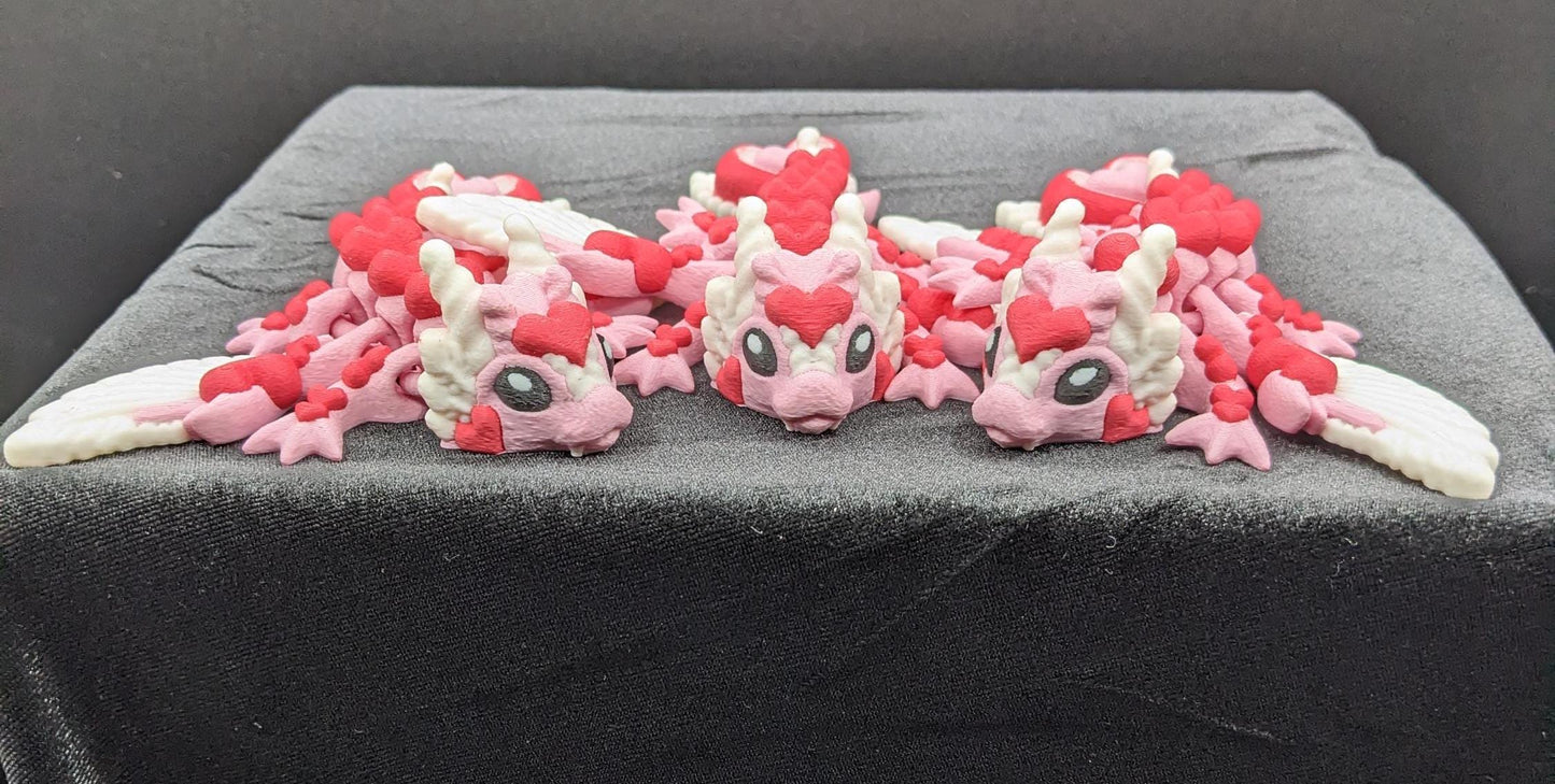 Discover the magic of our Valentine Heart Dragon! This enchanting articulating dragon not only graces your bookshelf with whimsy but also makes for a heartfelt and unforgettable Valentine's Day gift.