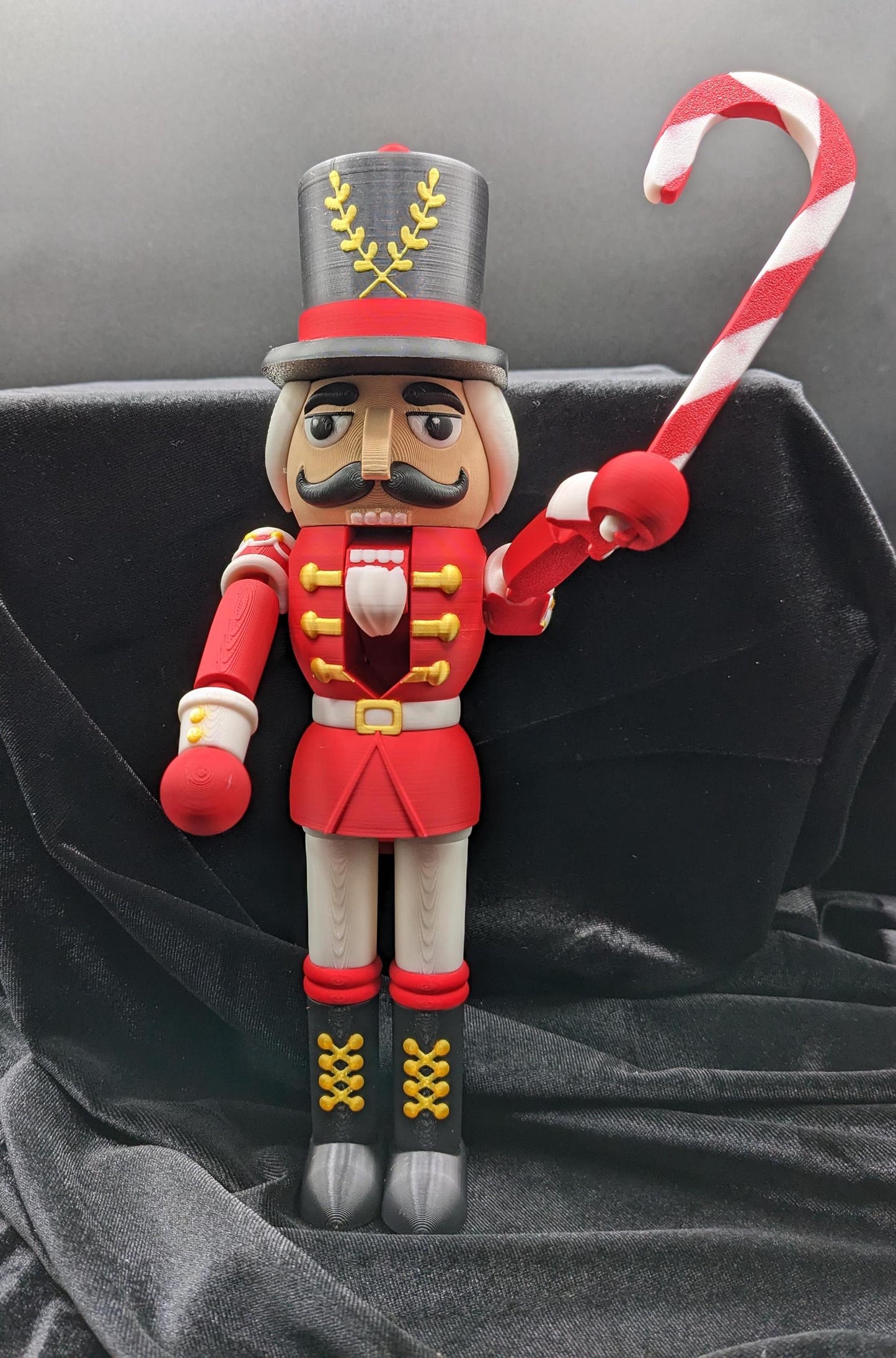 Celebrate the season with our Distinguished Articulated Christmas Nutcracker. Our handsome nutcrackers  can be posed to enhance its regal presence. Perfect for mantels, shelves, or as a centerpiece, a timeless addition to your holiday collection.