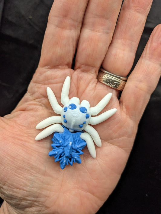 Capture the beauty of winter with our Articulated Snowflake Spider Fidget Toy! This one-of-a-kind spider features intricate snowflake design on its body adding a festive and elegant touch to its playful functionality.