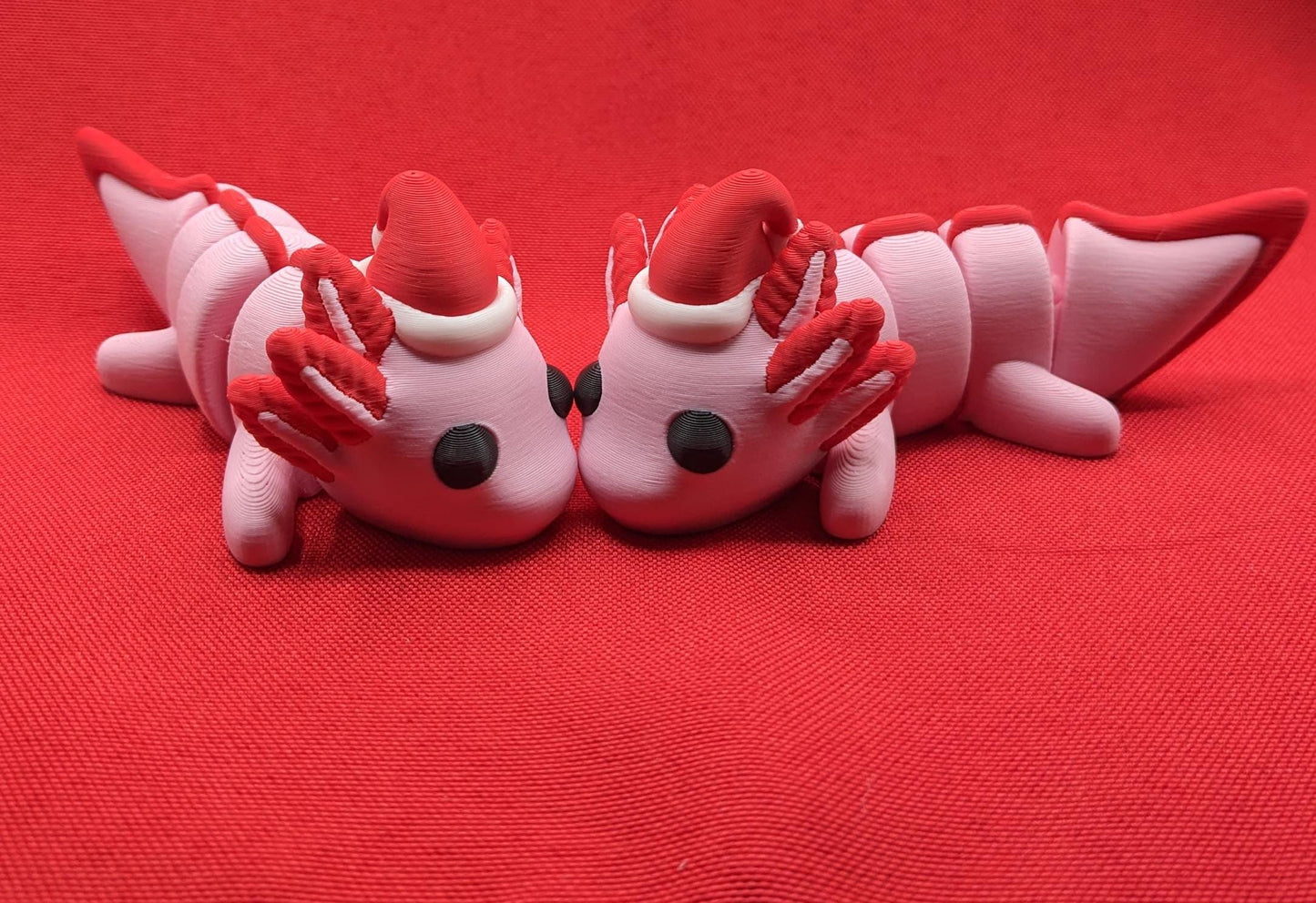 Celebrate the joy of the season with our Articulated Winter Christmas Axolotl Fidget Toy with a cute little Santa hat. This adorable and festive axolotl is perfect for spreading holiday cheer and providing endless fun.