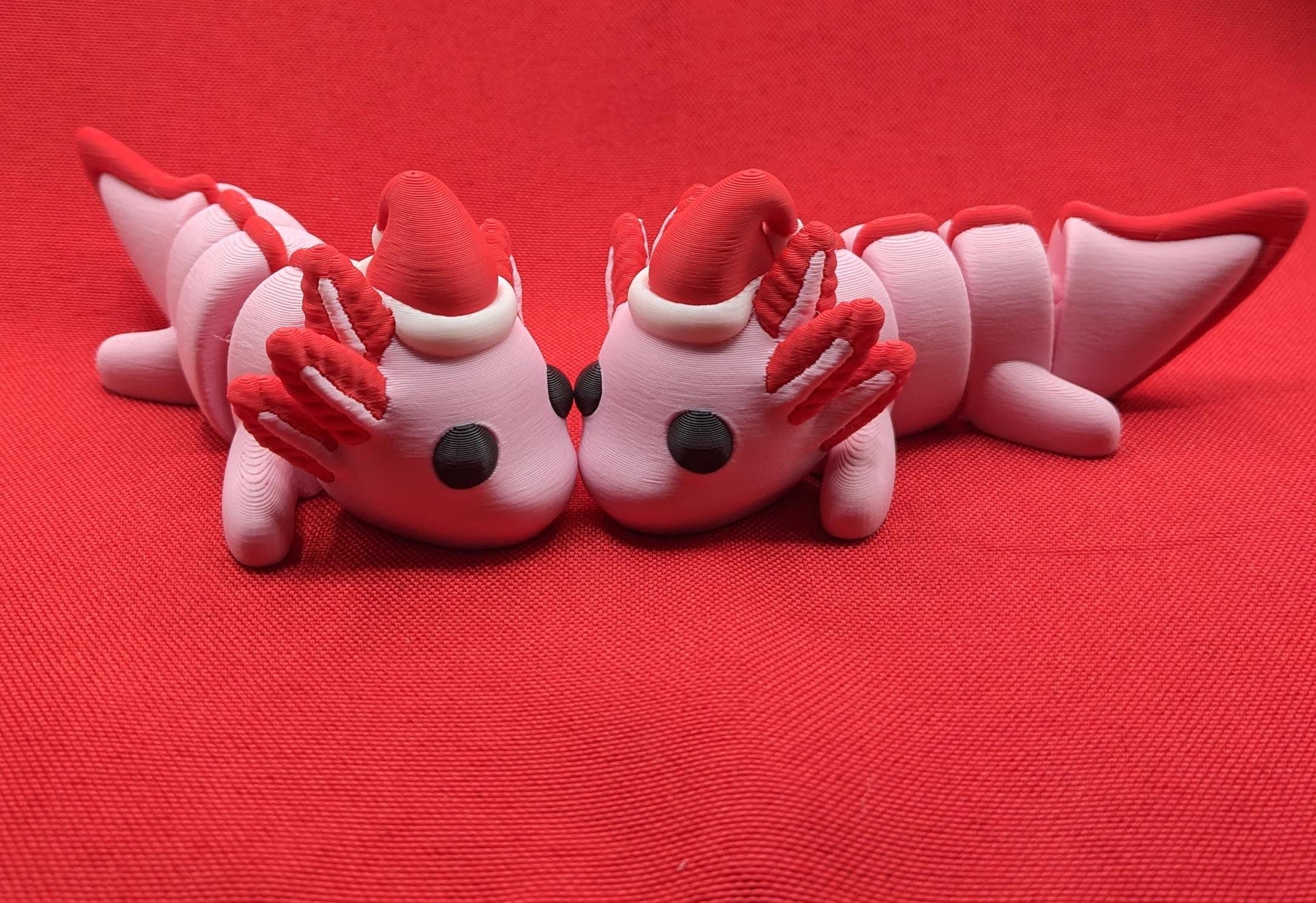 Celebrate the joy of the season with our Articulated Winter Christmas Axolotl Fidget Toy with a cute little Santa hat. This adorable and festive axolotl is perfect for spreading holiday cheer and providing endless fun.