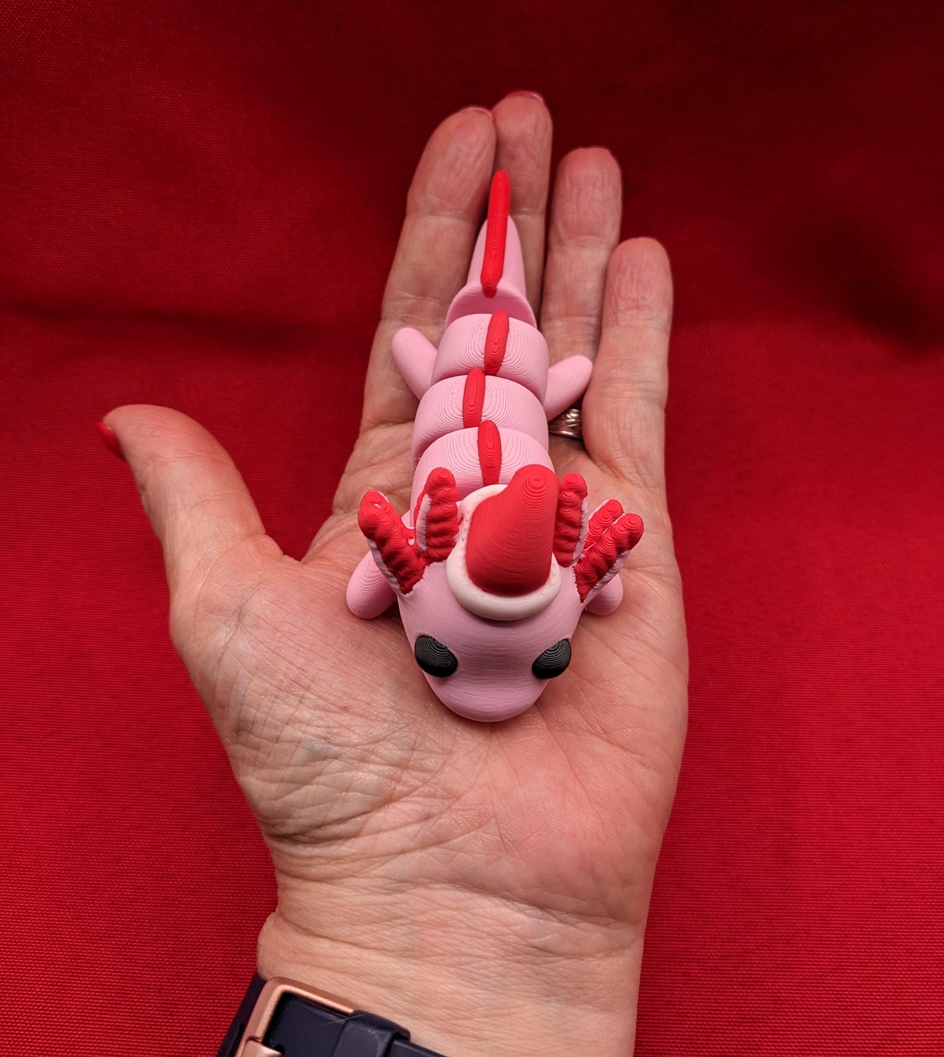 Celebrate the joy of the season with our Articulated Winter Christmas Axolotl Fidget Toy with a cute little Santa hat. This adorable and festive axolotl is perfect for spreading holiday cheer and providing endless fun.