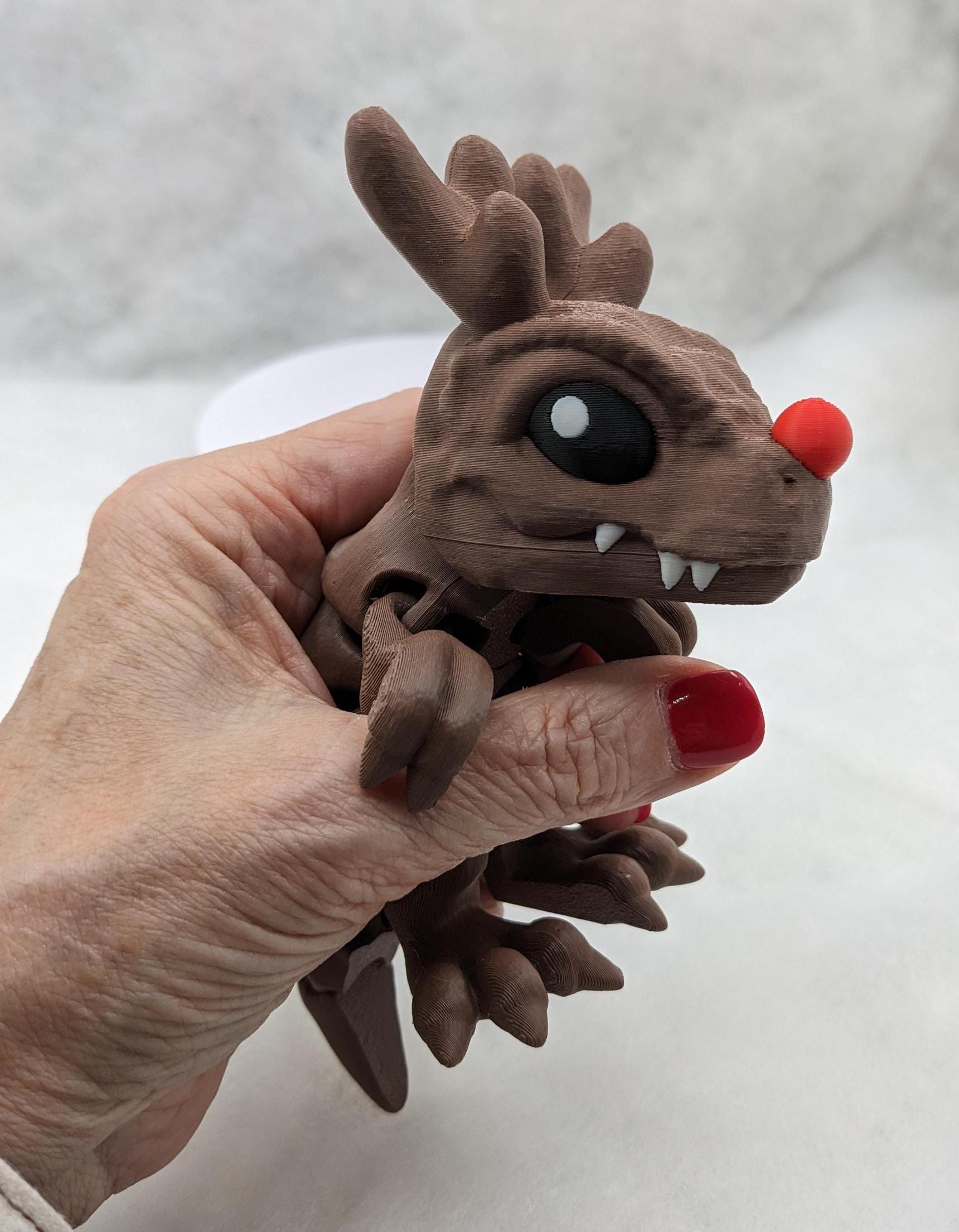 Our Christmas T-Rex combines the charm of Christmas with the fun of dinosaurs. An interactive toy for kids & adults alike,  articulated joints for posing & fidgeting, T-Rex is perfect as a stocking stuffer, desk toy, or playful holiday decoration.
